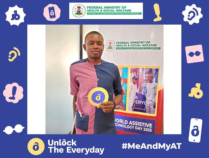 A young man with Me and My AT photoframe. He is holding Unlock the Everyday flyer