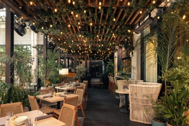 Aba rooftop patio in Fulton Market with string lights and lush greenery