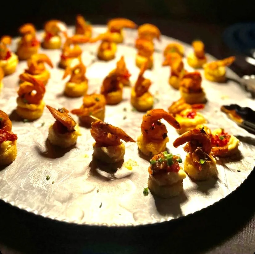   Cajun Shrimp on Cheesy Grit Cake  Smoked Gouda spread over a crisp grit cake, topped with bold Cajun shrimp. A Southern bite with serious flavor 