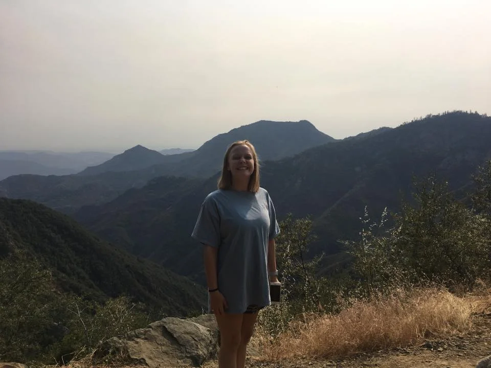 Shot of daughter with mountains in the background.