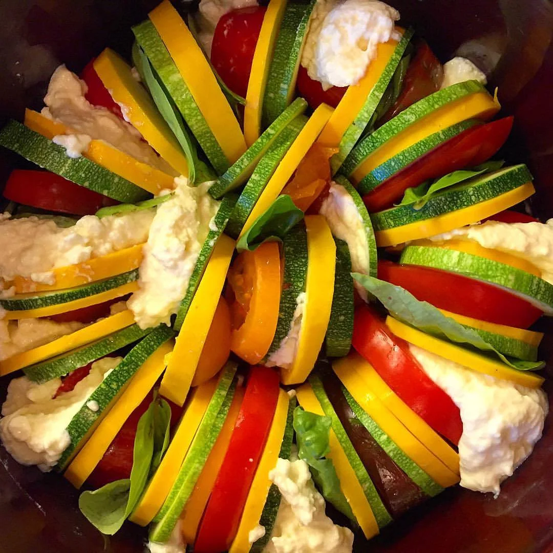 Tian of green and yellow summer squash, various shapes and sizes of garden tomatoes, leaves of Genovese basil the size of a baby’s hand, and quenelles of cow’s milk ricotta sprinkled with spicy Purple Stripe garlic and oregano flowers wrestled from the bees.
#garden #bounty #vegetables (at At Home in Napa)
