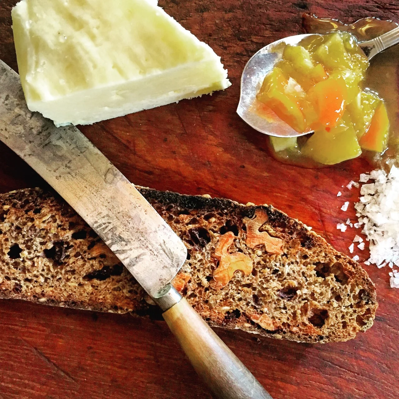 Sunday’s
pleasure dense slabs
of still-warm German rye sacrilege
with nuts and cranberry ripped and
dipped into bowls
of thick winter soup bleed into Monday
morning. Two slices
cut thin tucked into
a prized British toaster smaller
than a Mini Cooper until walnuts
just singe. Hand-molded
Beurre de Baratte, French for fatty,
salty, hedonistic preciousness recklessly slathered
without remorse. Hoarded
tangerine marmalade from Guru
Ram Das Orchard grown with
hippy sunshine and platitudes moans when
unscrewed, precursing wabi sabi ecstasy
of imprecisely chopped skins the
sweet-sour fragrance of young girlishness. Sea salt to
finish. The bread
singing now, its flavors
the high notes of a fermented symphony resounding
against the acoustic ceiling of my
palate melodious Monday morning
toast. #bread #toast #breakfast