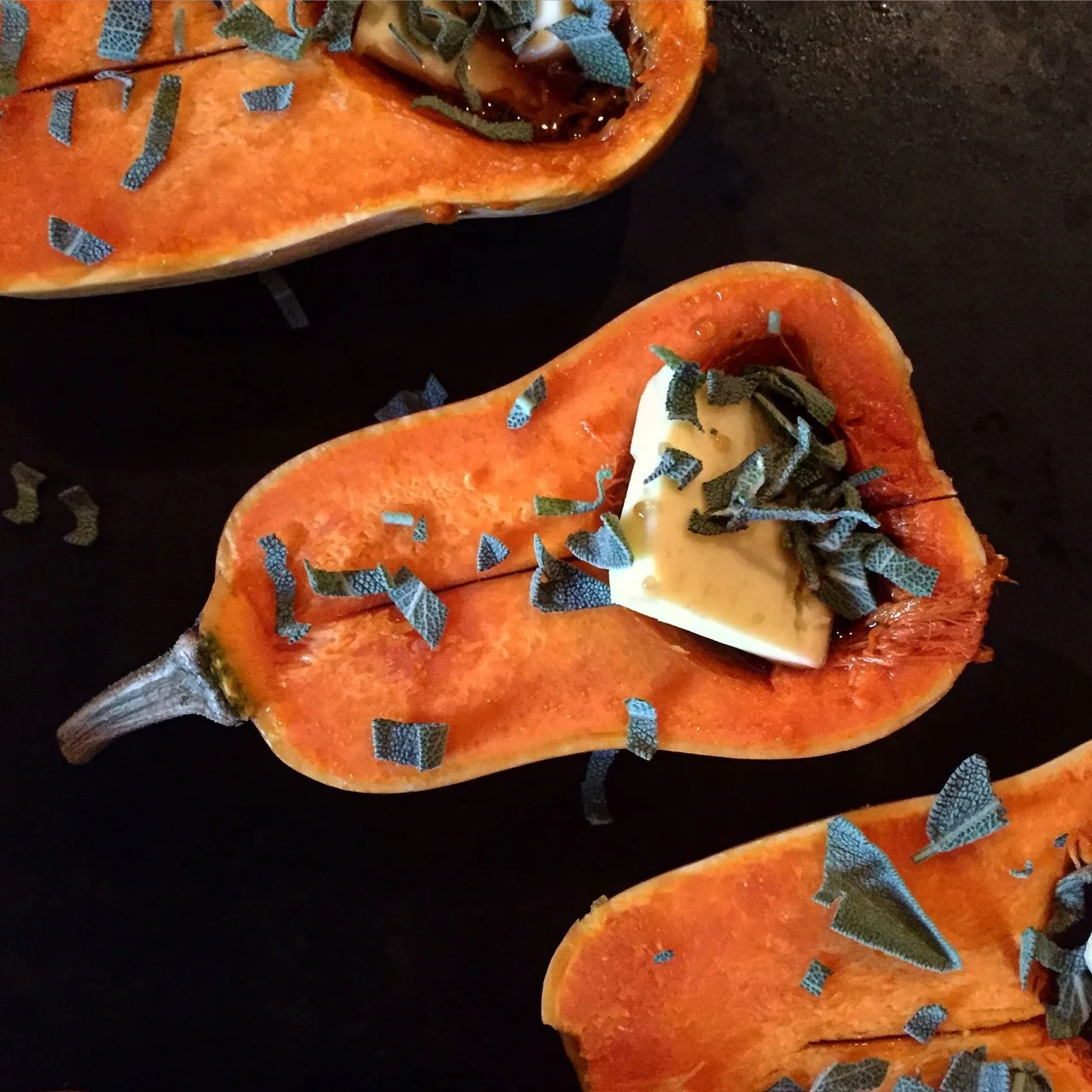 Honeynut squash with a dollop of salted butter, good maple syrup scored in Maine, and chopped garden fresh sage - roasted low and slow.
#roastedvegetables #autumn #squash