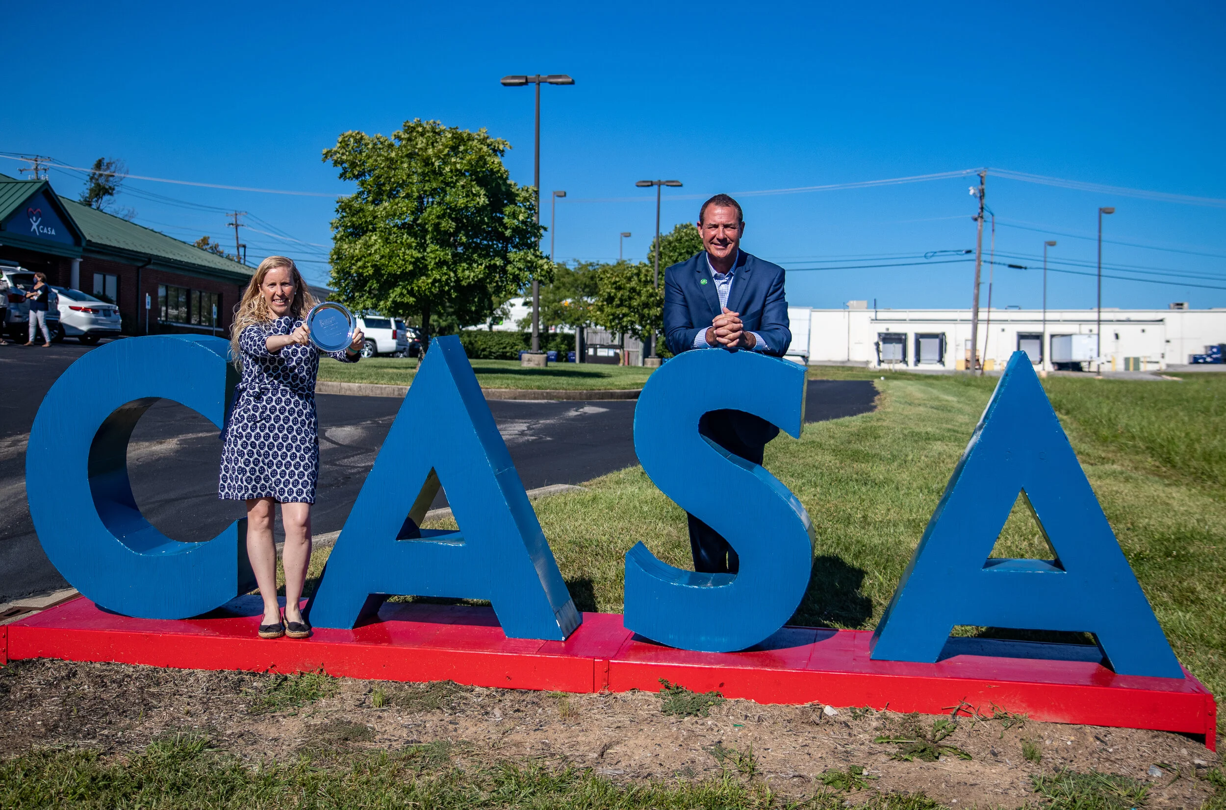 CASA of Lexington Executive Director Melynda Jamison, left, and Forcht Bank Lexington Market President Houston Hall stand with the Salute to Small Business Nonprofit Community Impact Award CASA of Lexington won as part of the 2020 Salute to Small Business Awards.