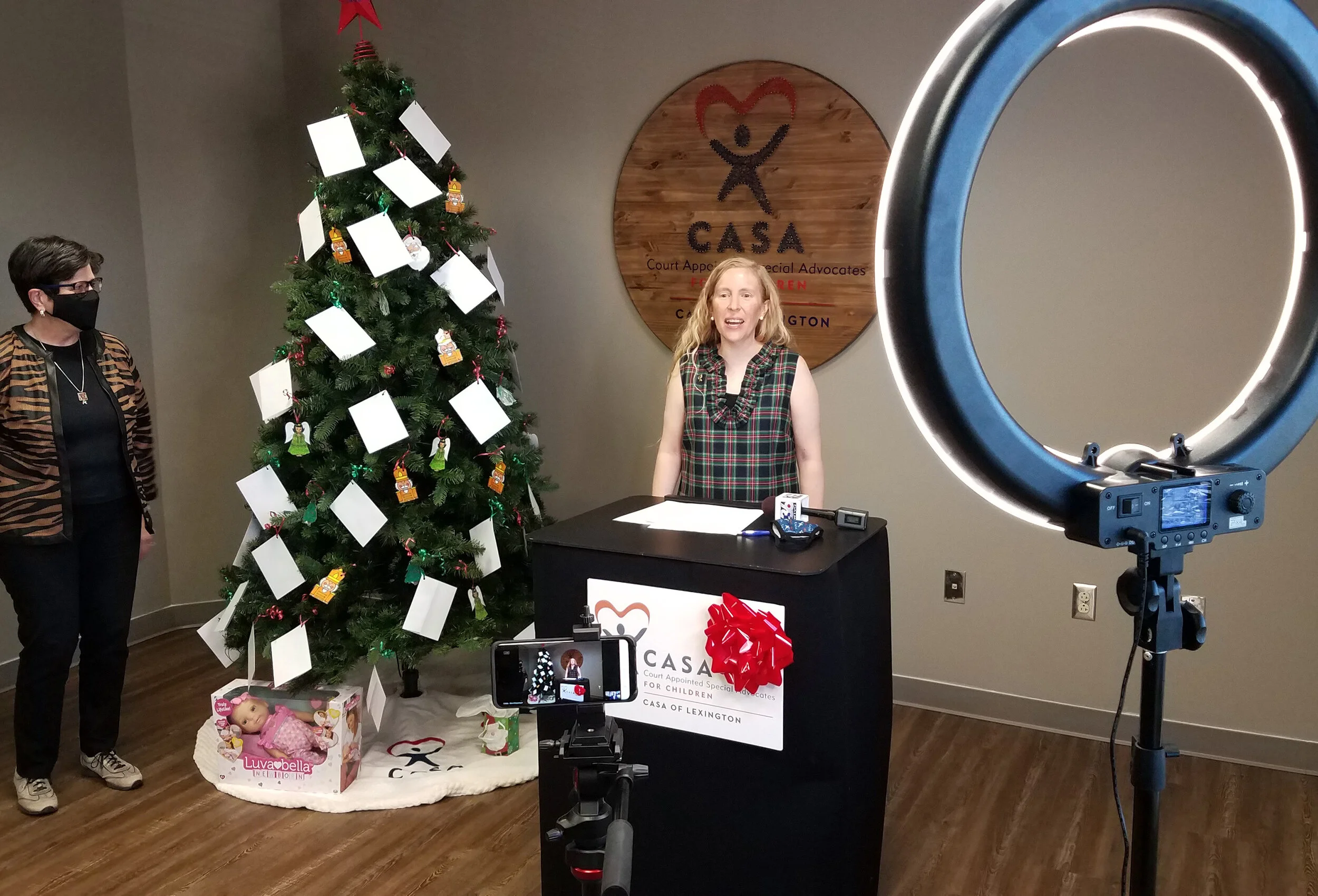 CASA of Lexington Executive Director Melynda Jamison, right, speaks to virtual attendees of the CASA Angel Tree lighting on Facebook Live Tuesday morning.