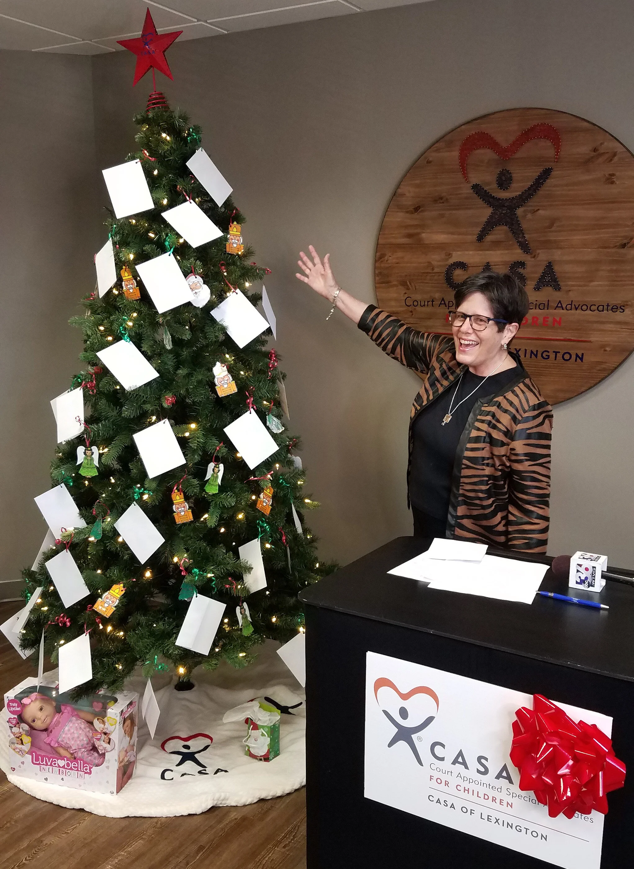 Lexington Mayor Linda Gorton flips the switch and lights the CASA Angel Tree at CASA of Lexington's office Tuesday morning.