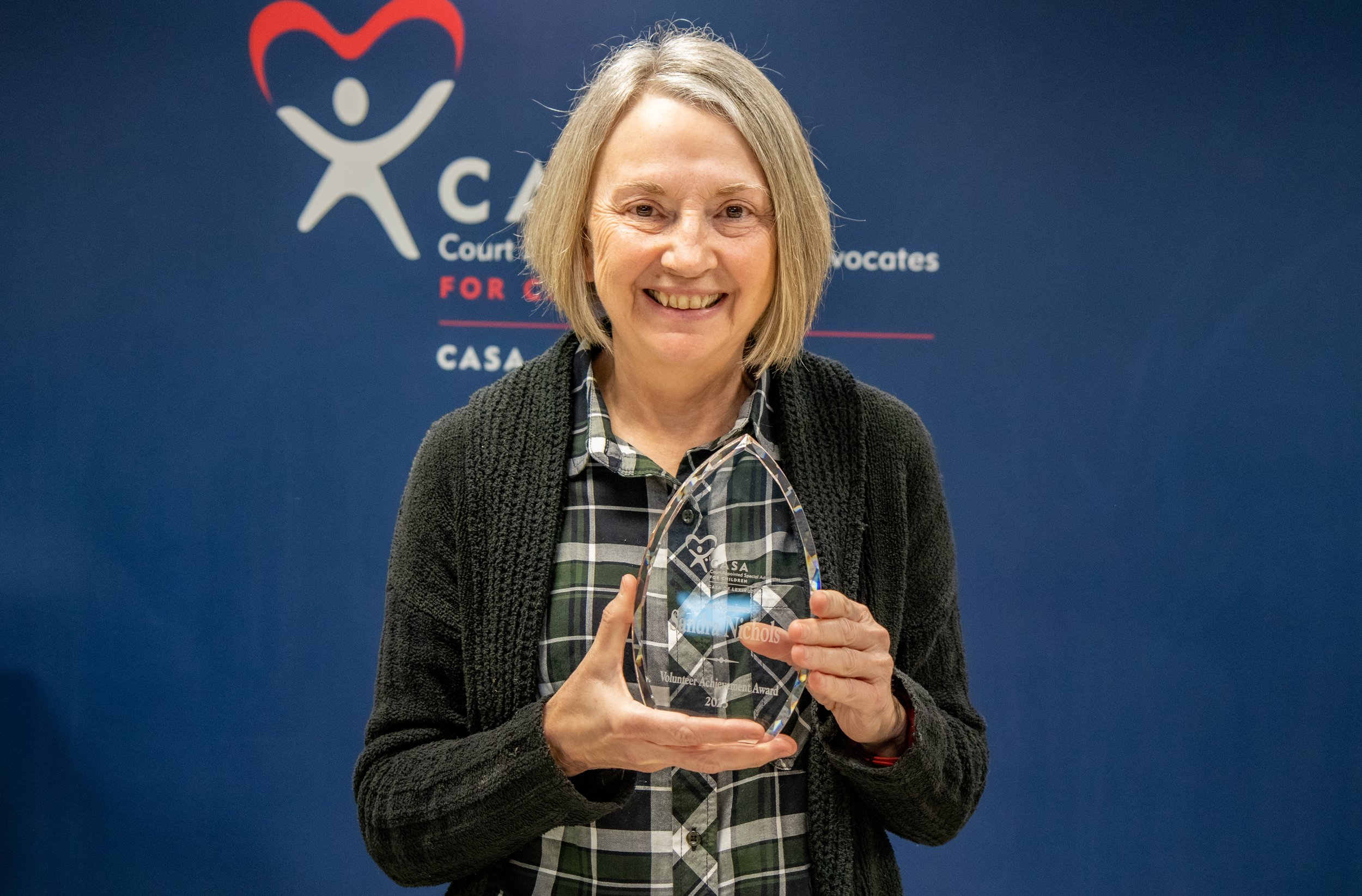 CASA of Lexington volunteer Sandy Nichols holds her Volunteer Achievement Award, which she earned by providing years of invaluable advocacy in a particularly difficult family court case.