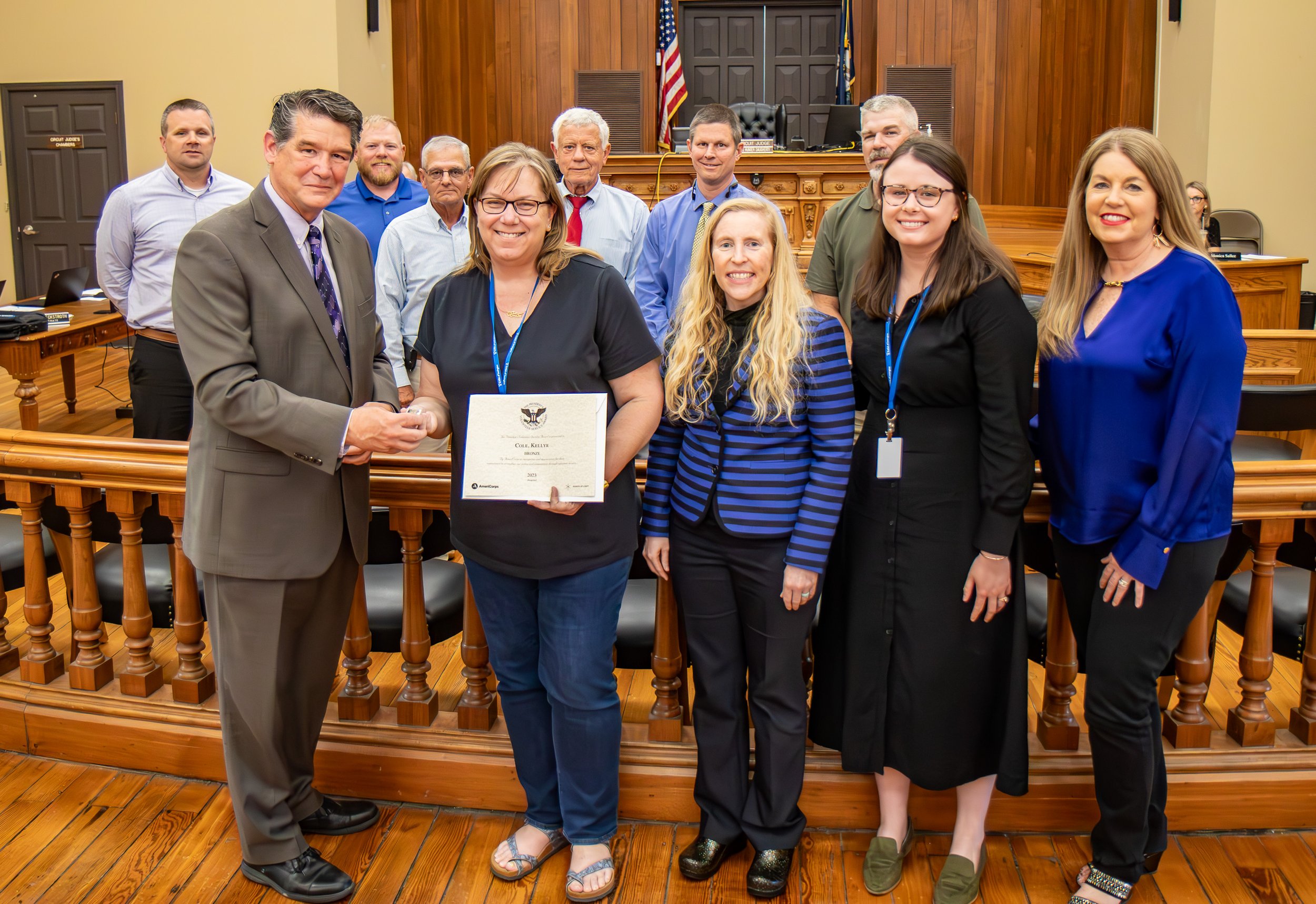 Jessamine County Judge-Executive David West, front left, presents Jessamine County CASA Volunteer Kellye Cole with her Presidential Volunteer Service Award at Tuesday’s Jessamine Fiscal Court meeting.