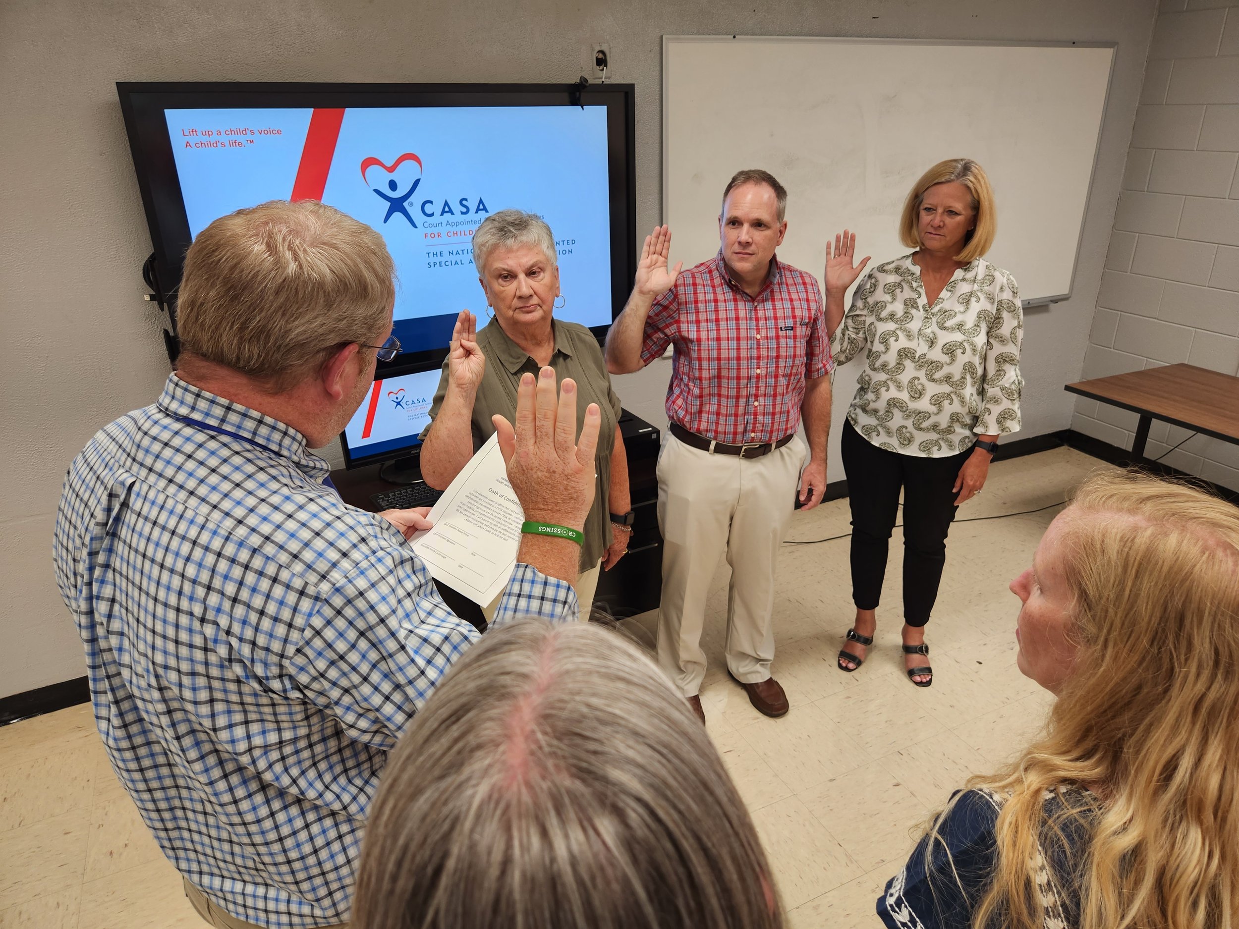 Family Court Judge Jeff Moss swears in the three newest CASA volunteers serving abused and neglected children in Garrard and Lincoln counties.