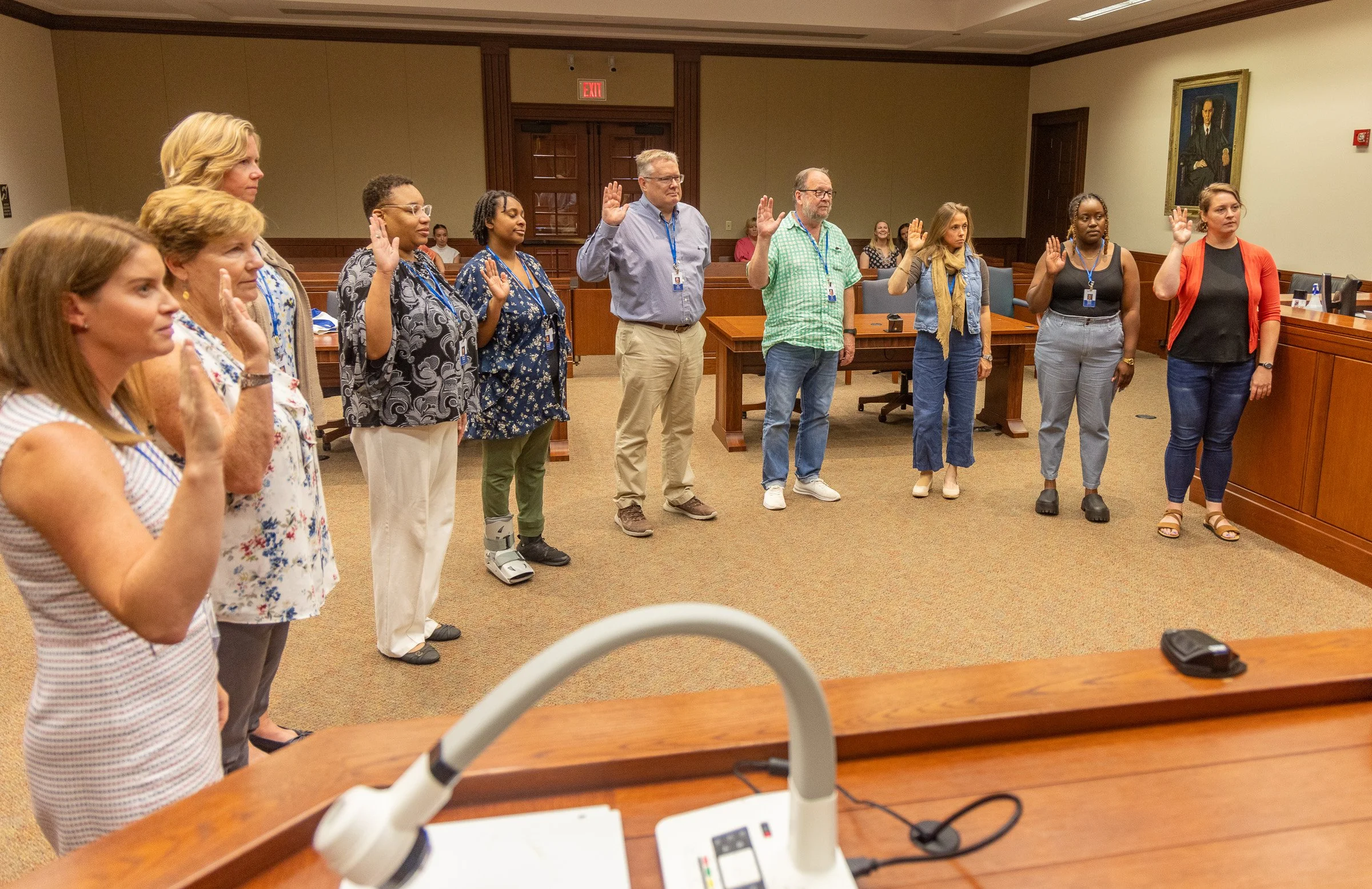 Nine new CASA volunteers and a state CASA employee are sworn in by Family Court Judge TIffany Yahr on June 30.