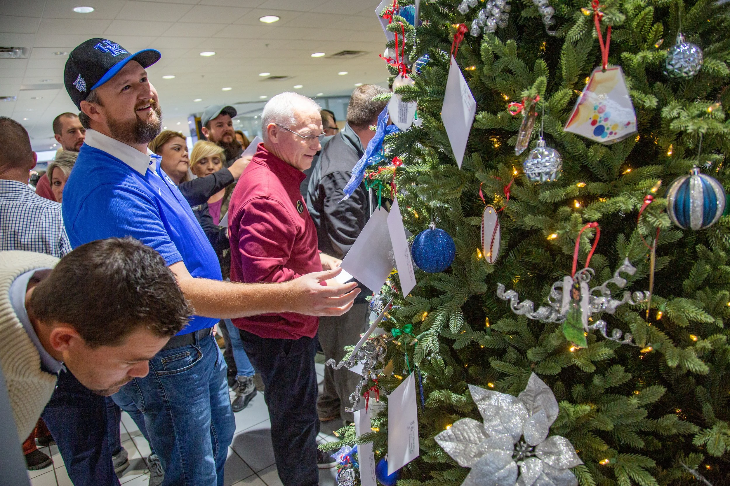 Participants pick names of children in need of holiday gifts from the CASA Angel Tree Tuesday.
