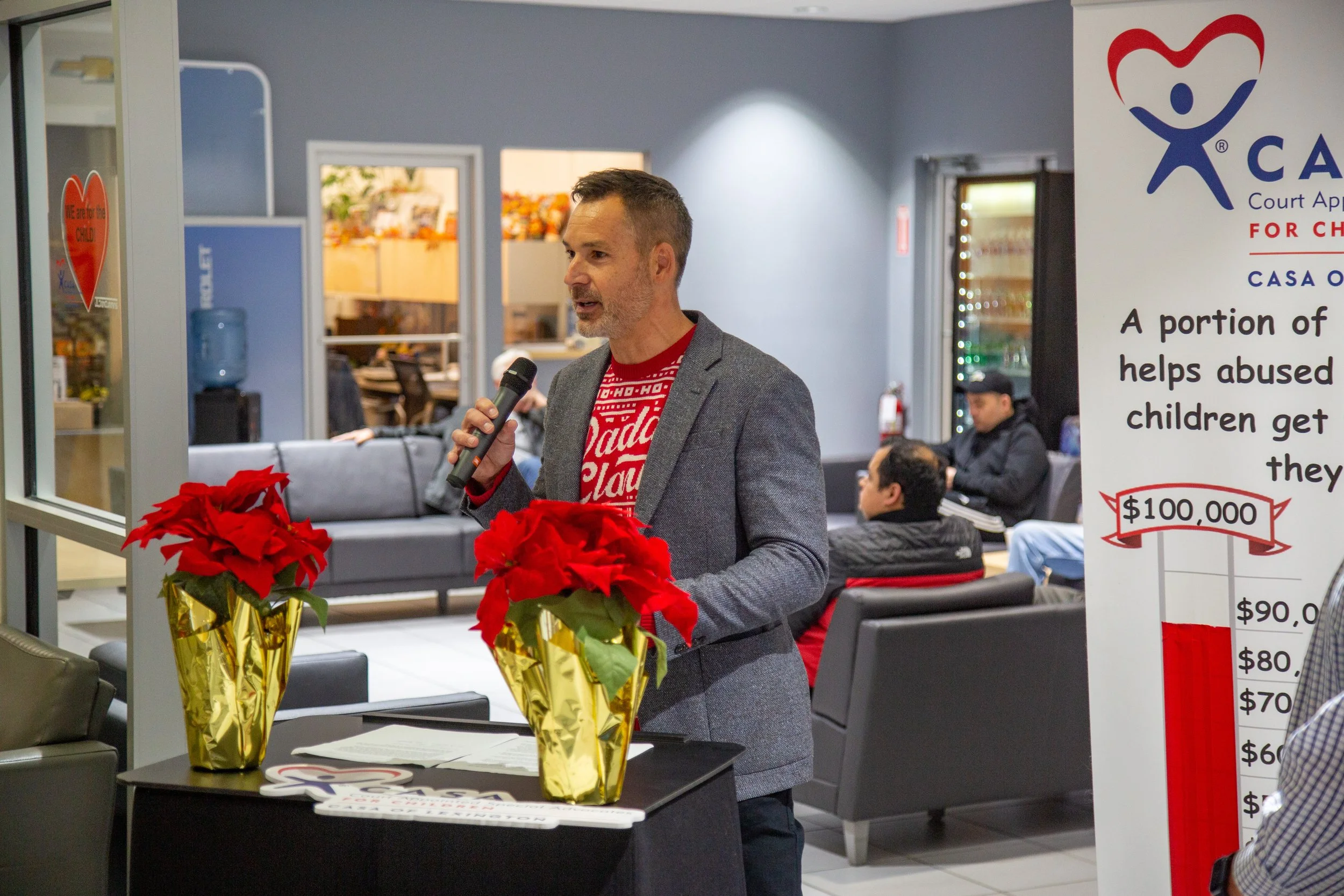 Josh Cummins speaks about the need to break cycles of abuse during the CASA Angel Tree event Tuesday.