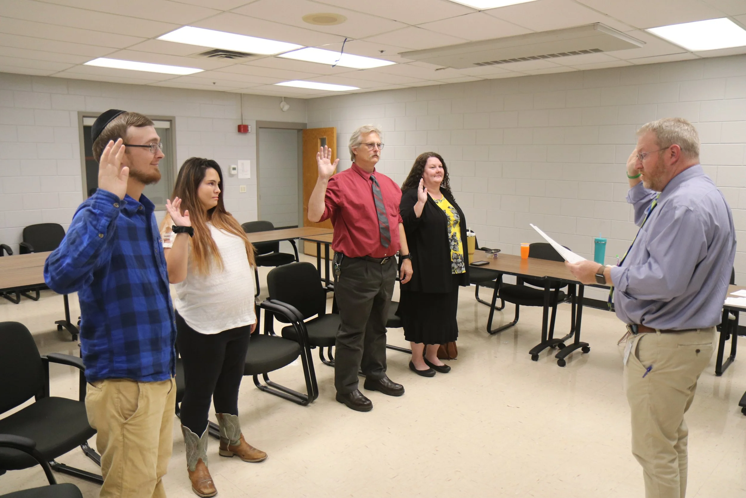 Family Court Judge Jeff Moss swears in four new CASA volunteers, who will now begin advocating for the best interests of abused and neglected children in Garrard and Lincoln counties.