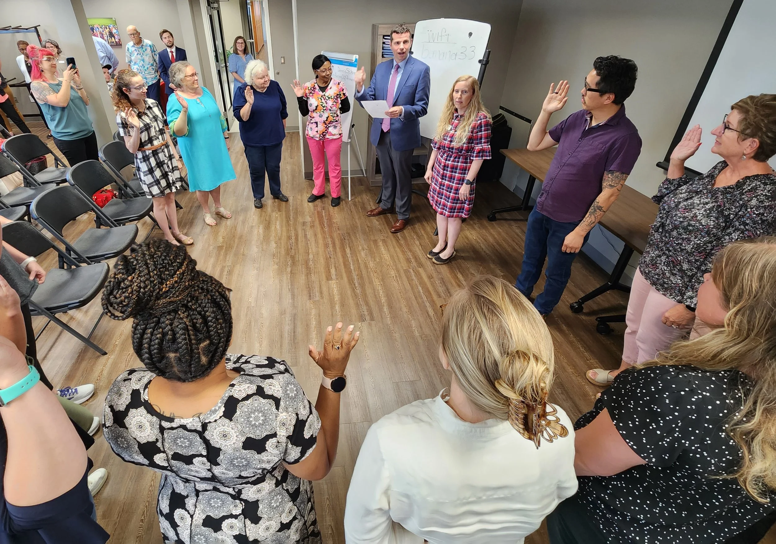 Family Court Judge Ross Ewing, top center, swears in new CASA volunteers May 30.