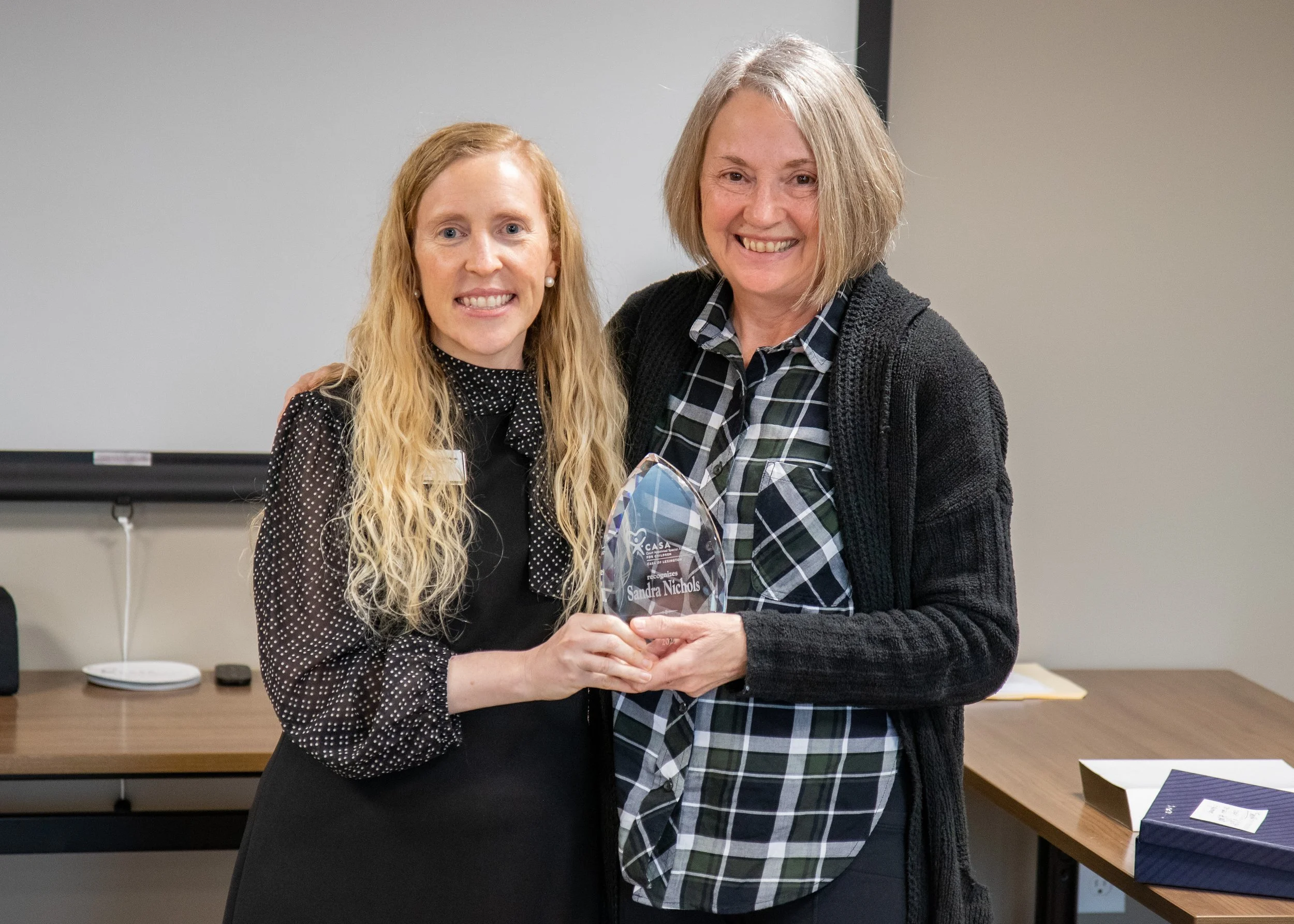CASA of Lexington Executive Director Melynda Jamison presents Sandy Nichols with her Volunteer Achievement Award.