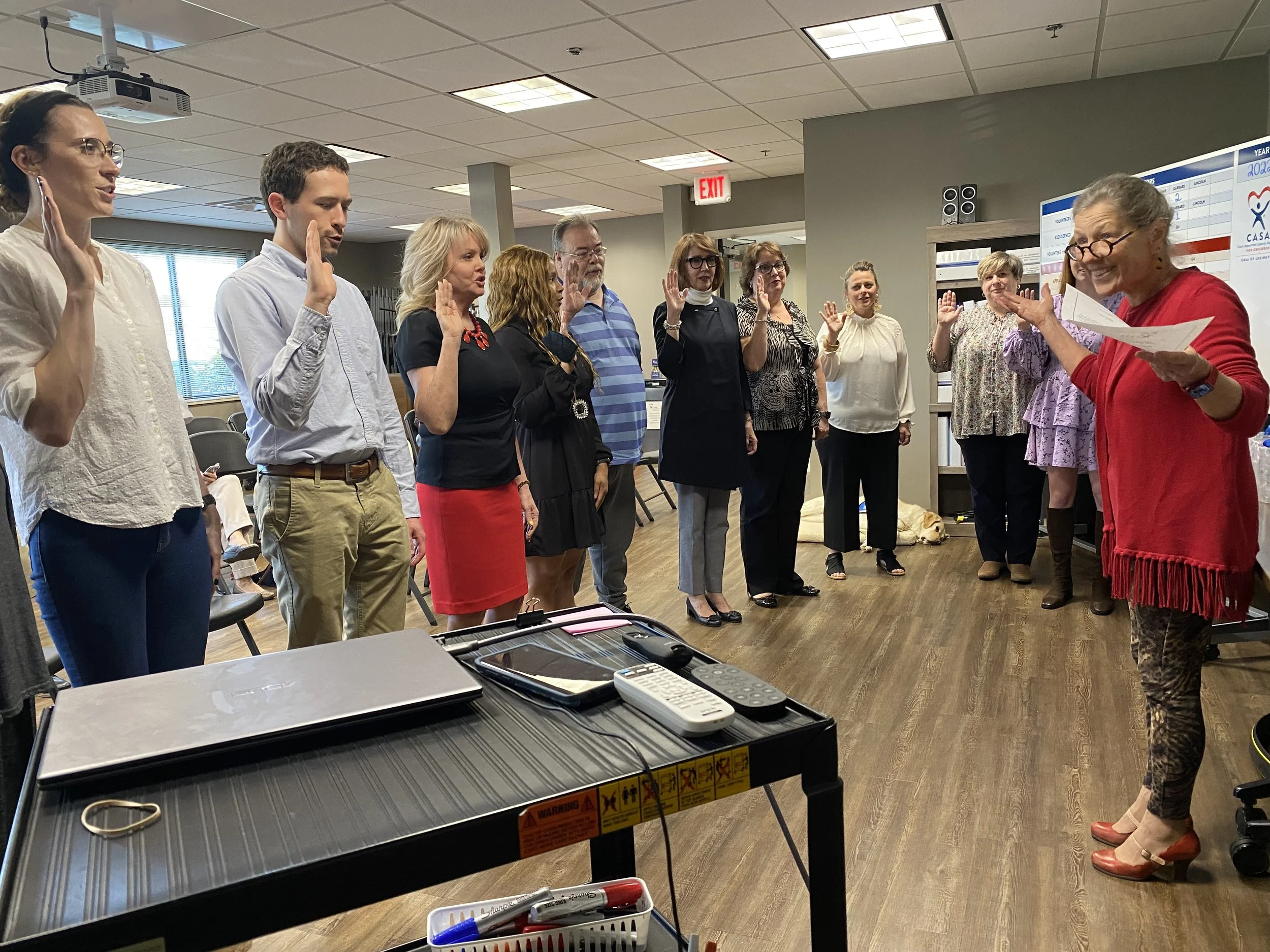 Fayette Family Court Judge Lucinda Masterton, far right, swears in the newest class of CASA volunteers on April 14.
