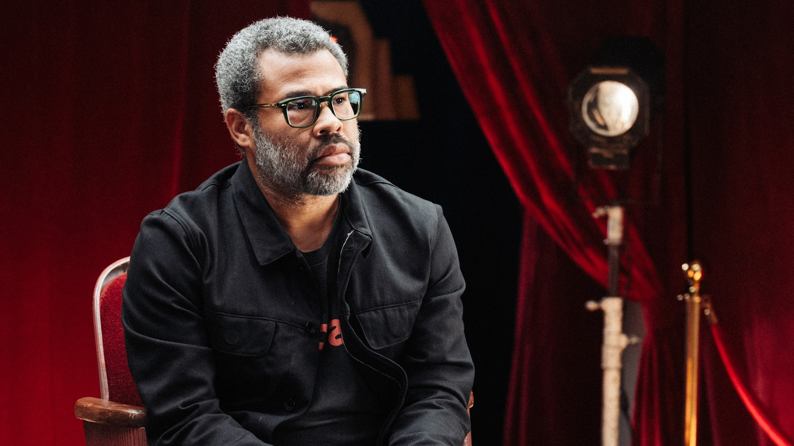 Jordan Peele in front of a red curtain, High Horse on Peacock.