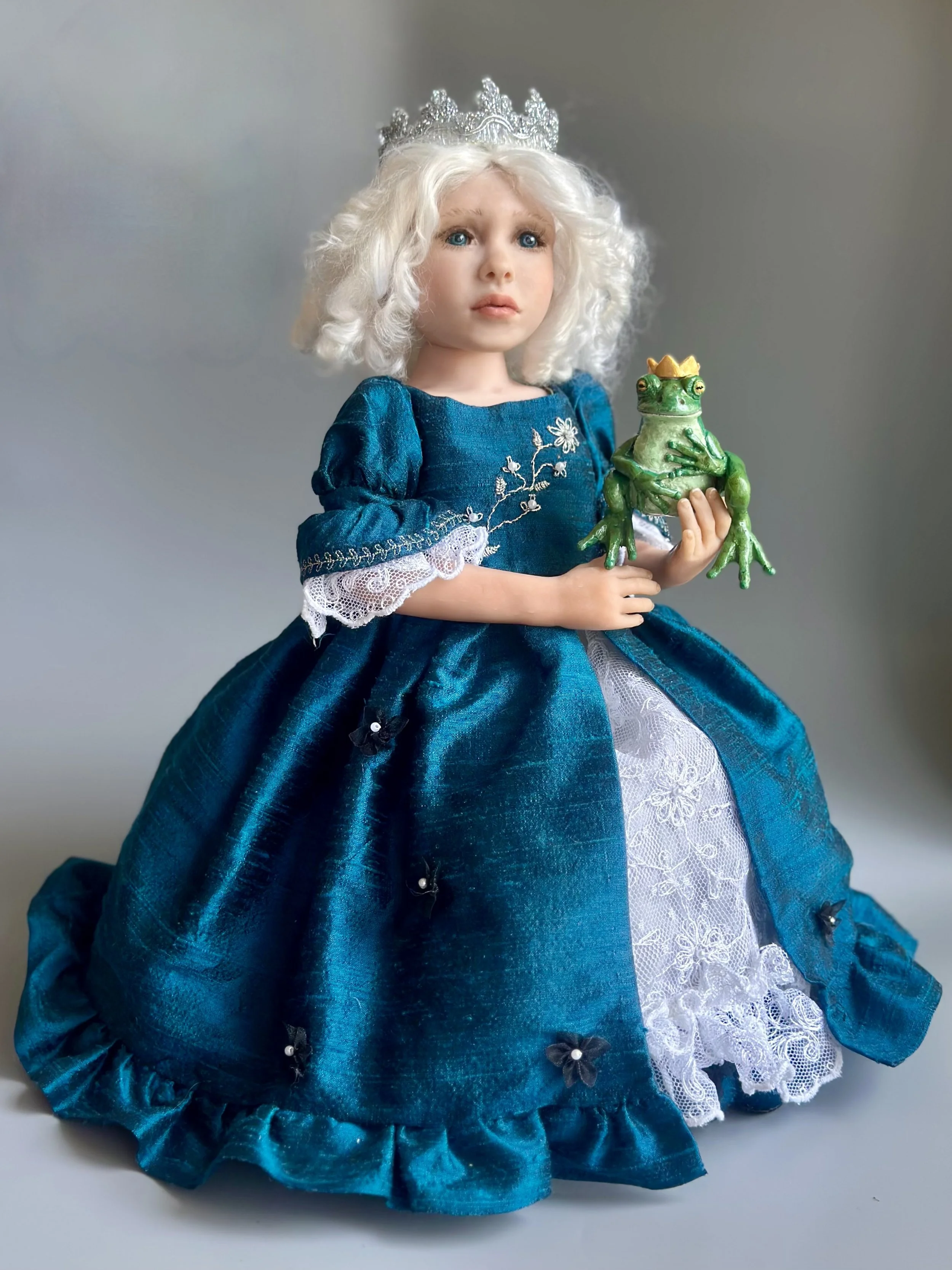  Princess and the Frog   If standing, the doll would be 14”.  She is polymer clay with a mohair wig, handprinted eyes, silk dress, lace and silk petticoat, matching shoes, and a little frog prince that she can’t bring herself to kiss.  $750 