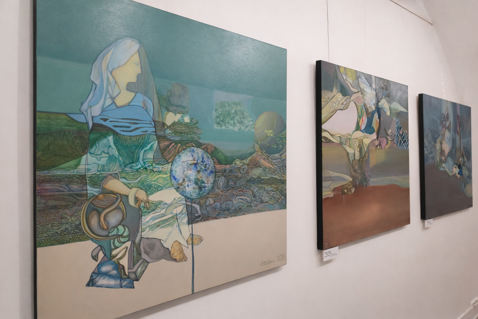 Angled view of three oil paintings by Alexey Adonin at Jerusalem Rainbow: Magic of Color, Skizza Gallery, Jerusalem, 2019.