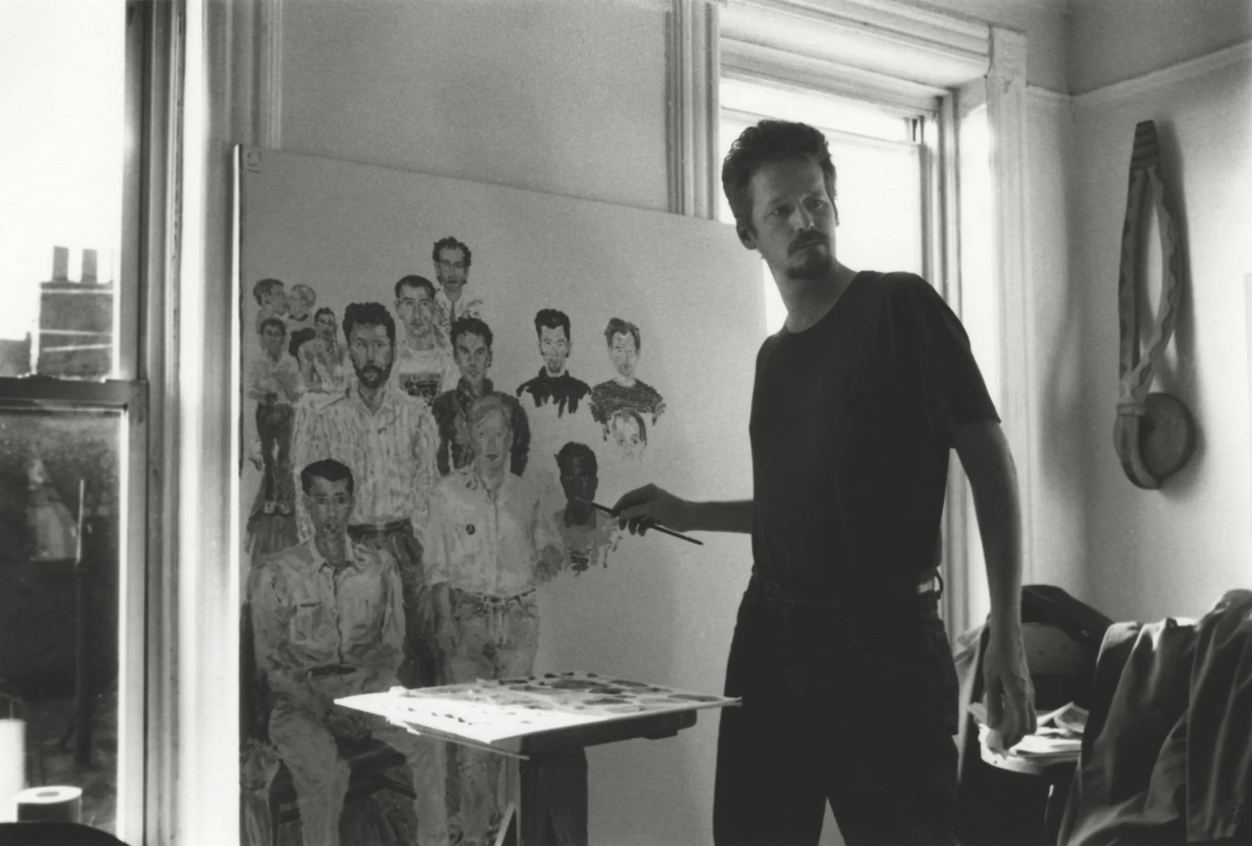 Black and white image of man painting
