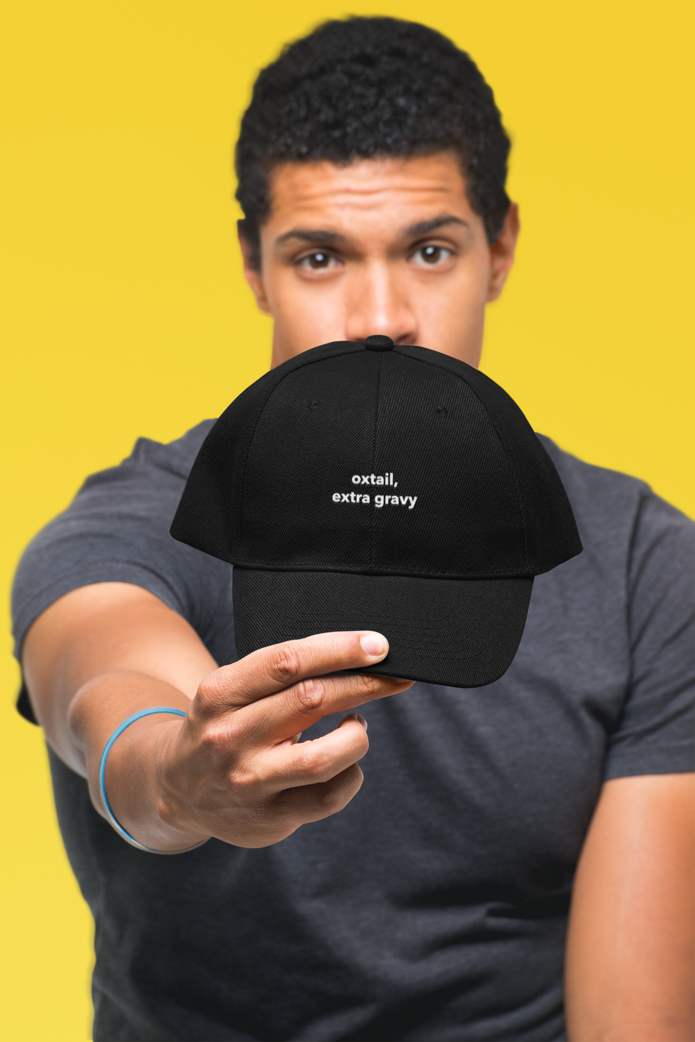 mockup-of-a-man-showing-off-his-dad-hat-in-a-studio-27046 (1).png