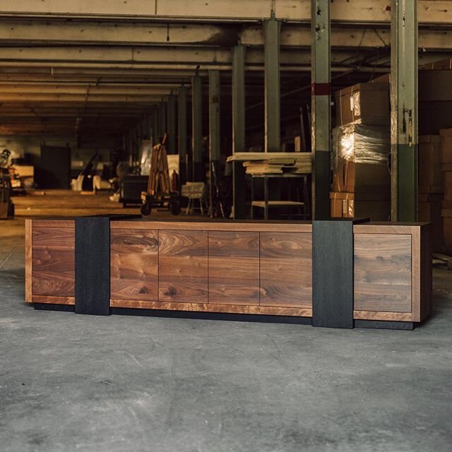 [ Credenza ]

Nine beautiful feet of solid box jointed walnut. Handsomely wrapped with two solid ebonized oak bands.
The flat cupboard doors, with a simple push touch opening, completing the custom design. 
Sleek, solid, sophisticated, and all ready 