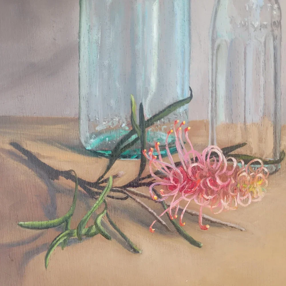 up close detail of the grevillea laying on the wooden bench.webp