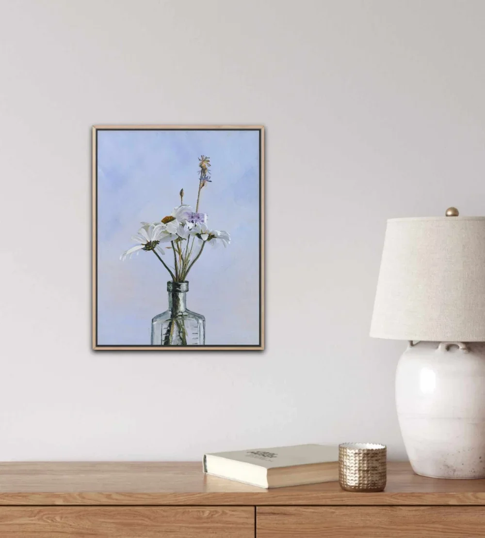 Daisy Love framed in oak and on a wall above an oak cabinet.