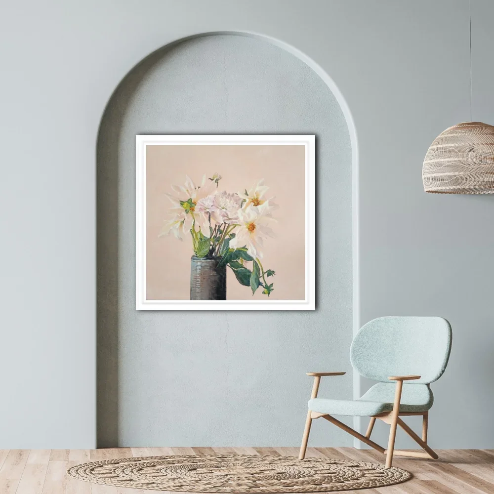 Dahlia paper print framed in white and hanging in an arched recess beside a coastal decor chair.
