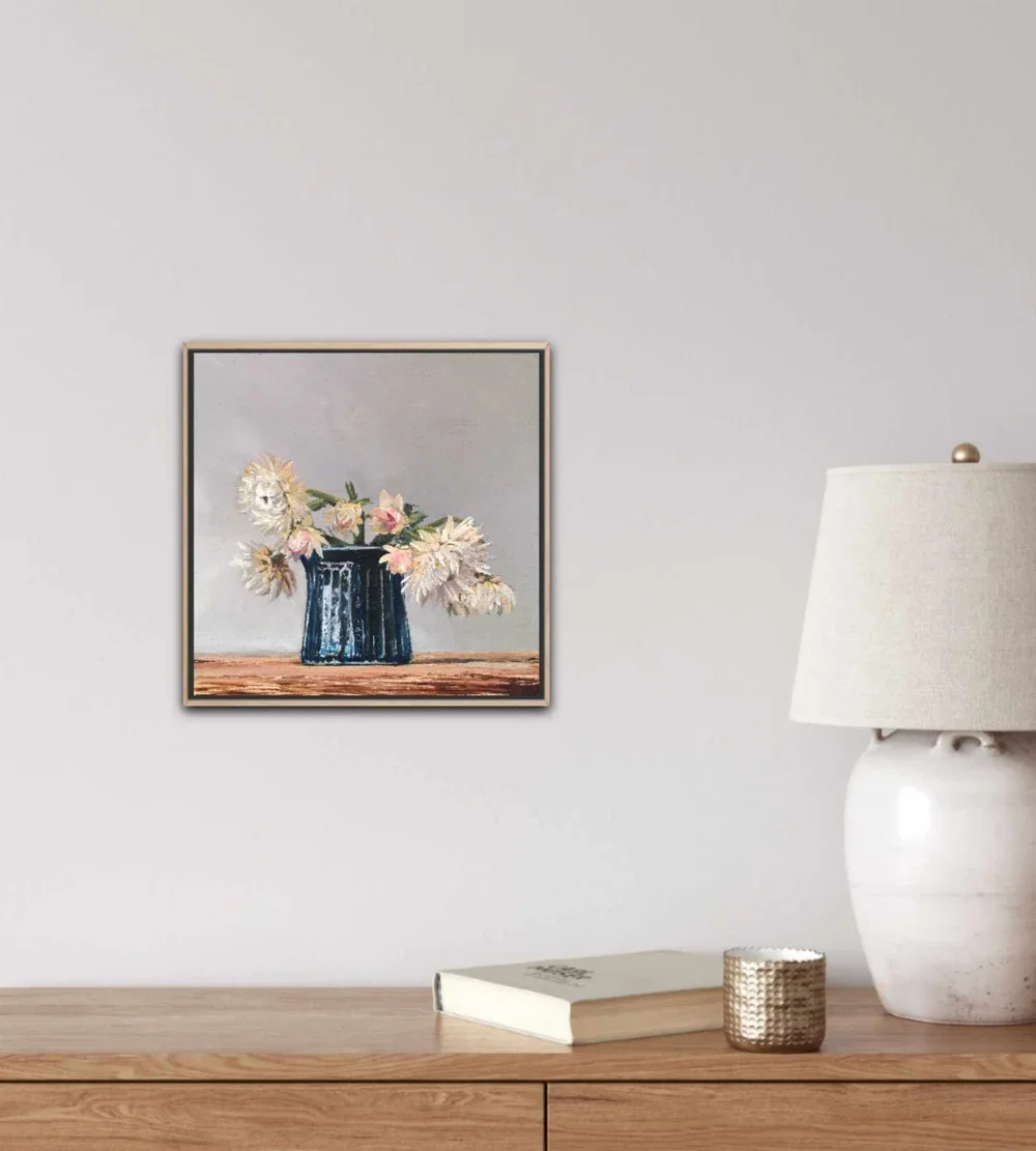 Contentment framed in oak above a neutral dresser.webp