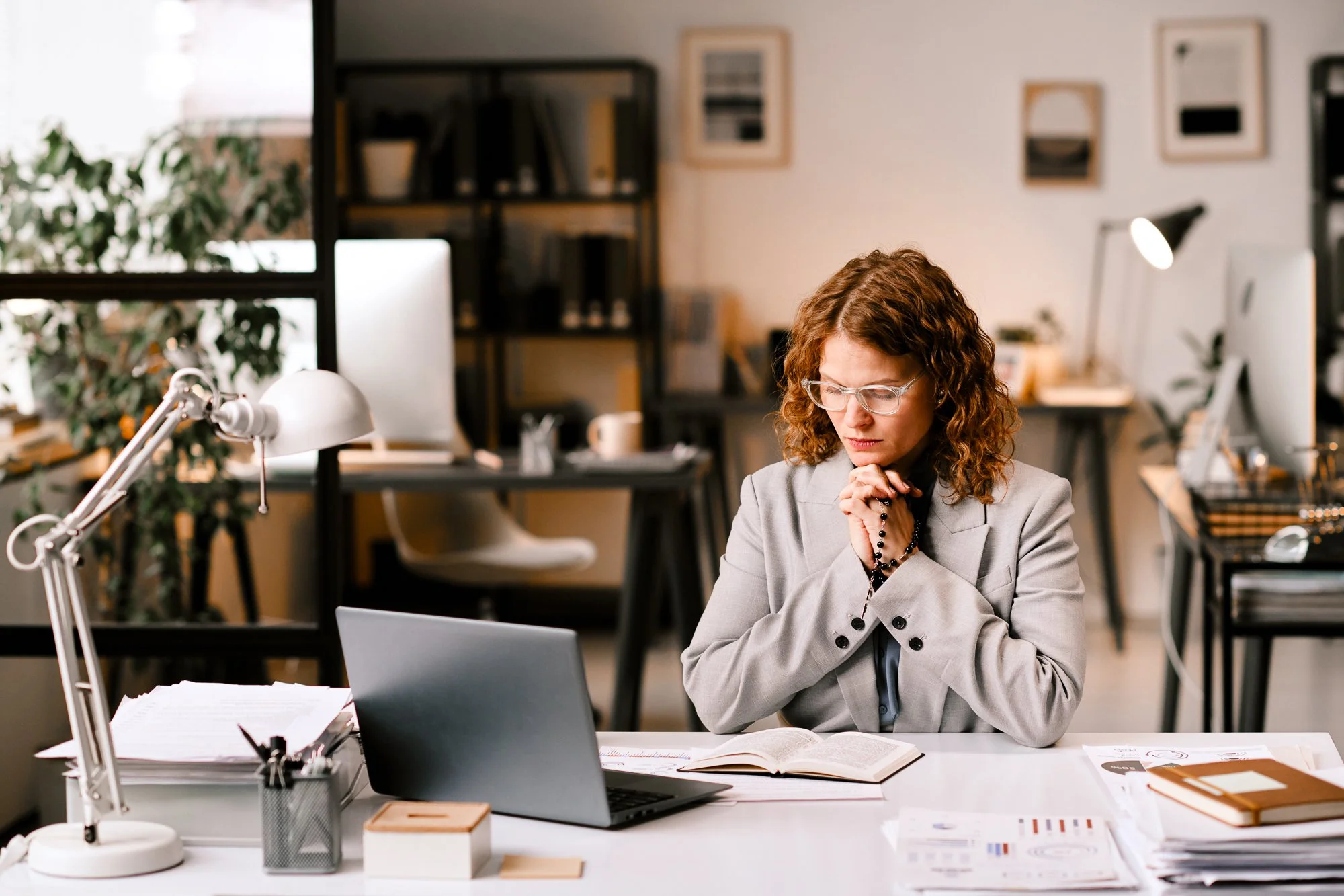 woman praying at her desk