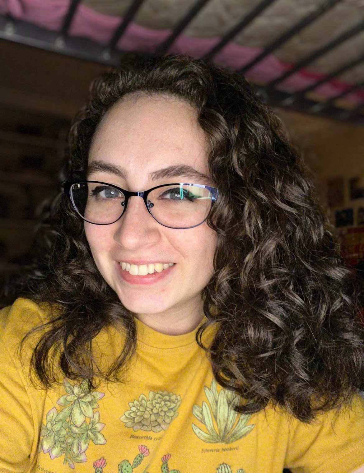 Anna McCorkle in a yellow t-shirt smiling at the camera