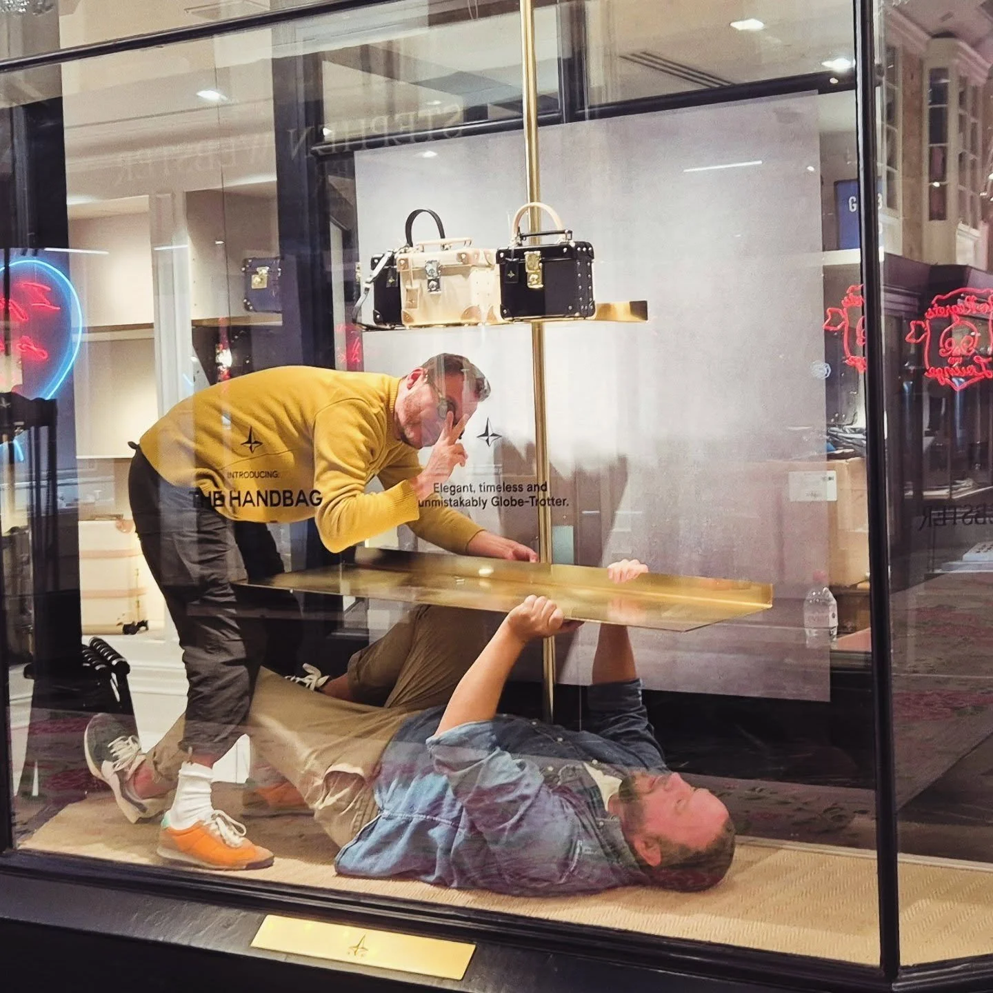 I thought this was an art installation, but no, it's two guys trying to fix a shelf!