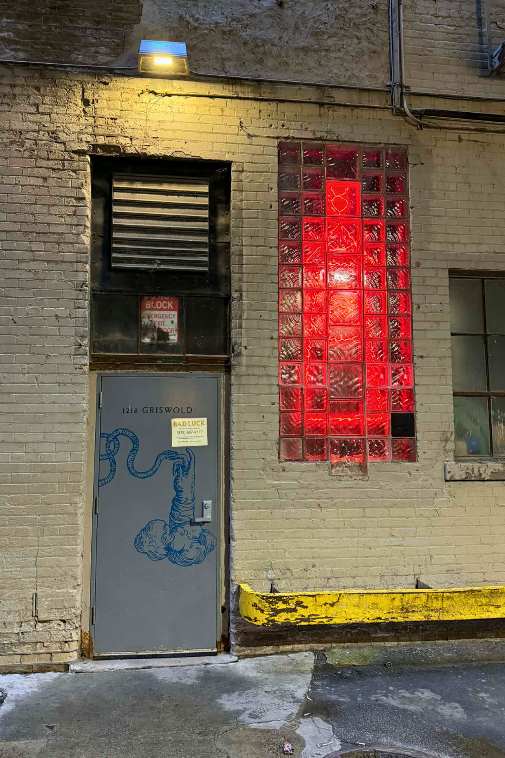 Snake coiled on a door is the only sign for Bad Luck Bar