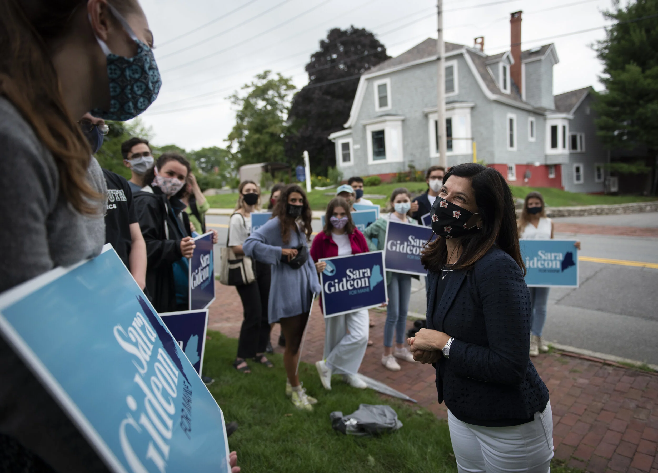 Democratic candidate for U.S. Senate Sara Gideon, right, meets with her supporters outside a polling place in Portland on the day of the Maine State Primary on July 14, 2020. Gideon won the primary, becoming the official Democratic nominee to take o
