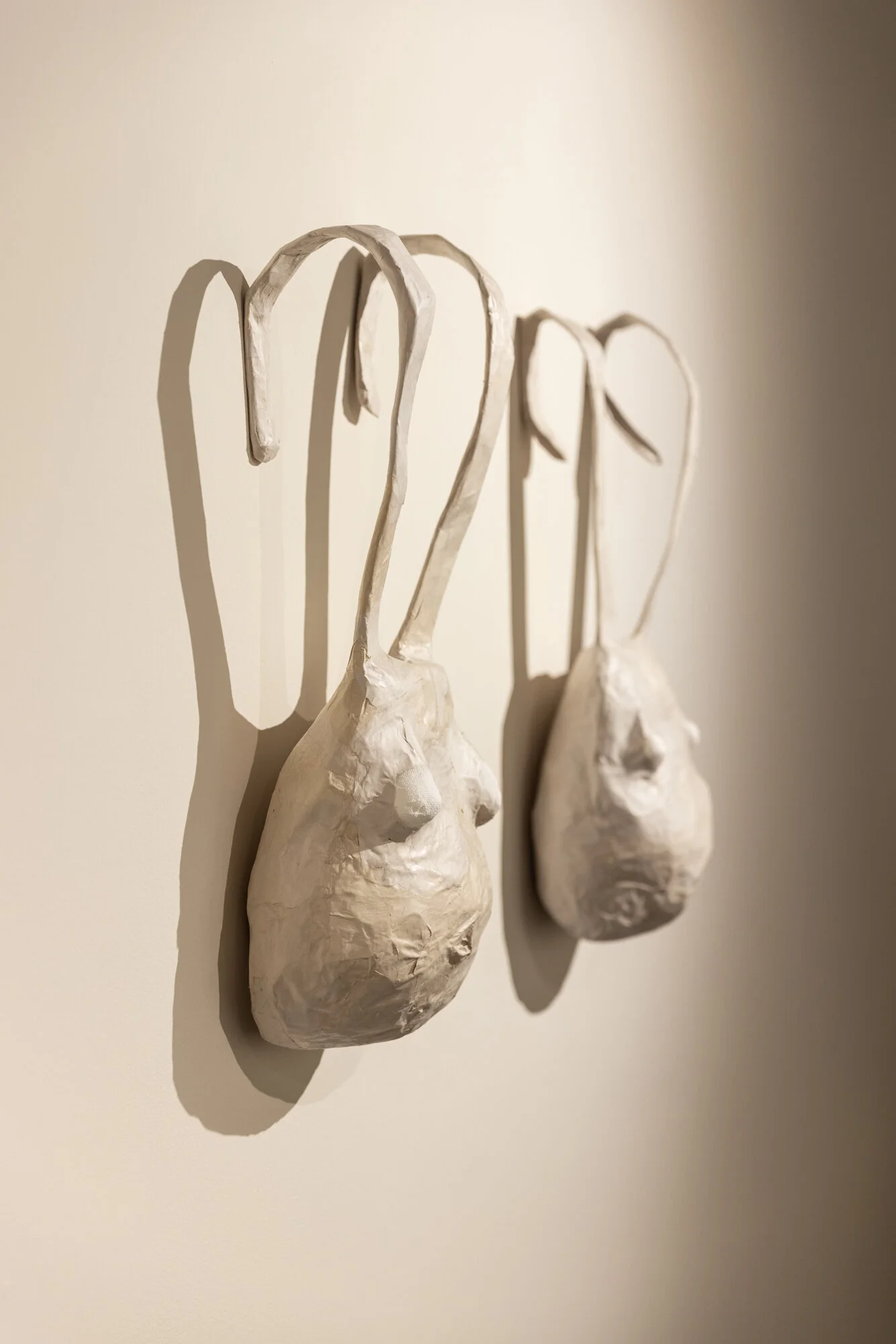   HARNISS 1 &amp; 2  (side view), papier-mâché, 28 x 15 x 8” each, 2021   