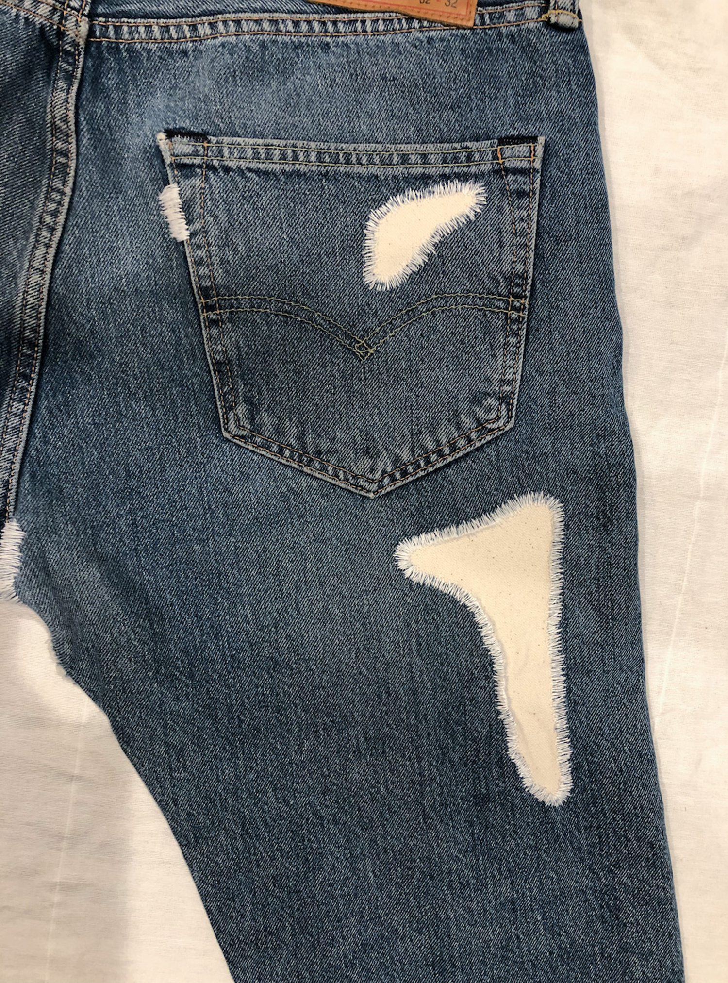 07_ORGANIC_PATCHWORK_LEVIS_501_JEAN_PRODUCT_BACK_DETAIL_WEB_01.18.22.png