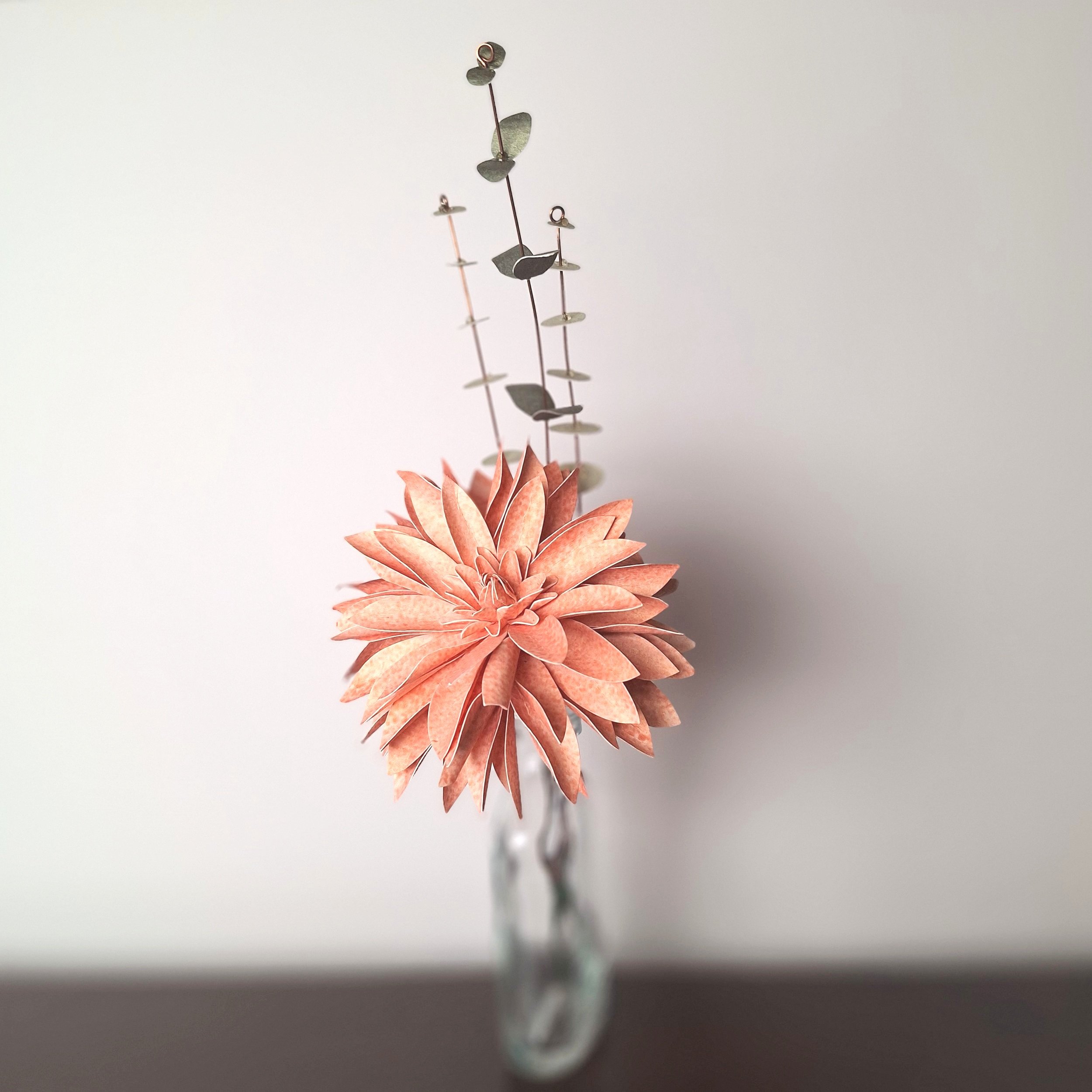 handmade paper flower dahlia in peach, with leafy stems