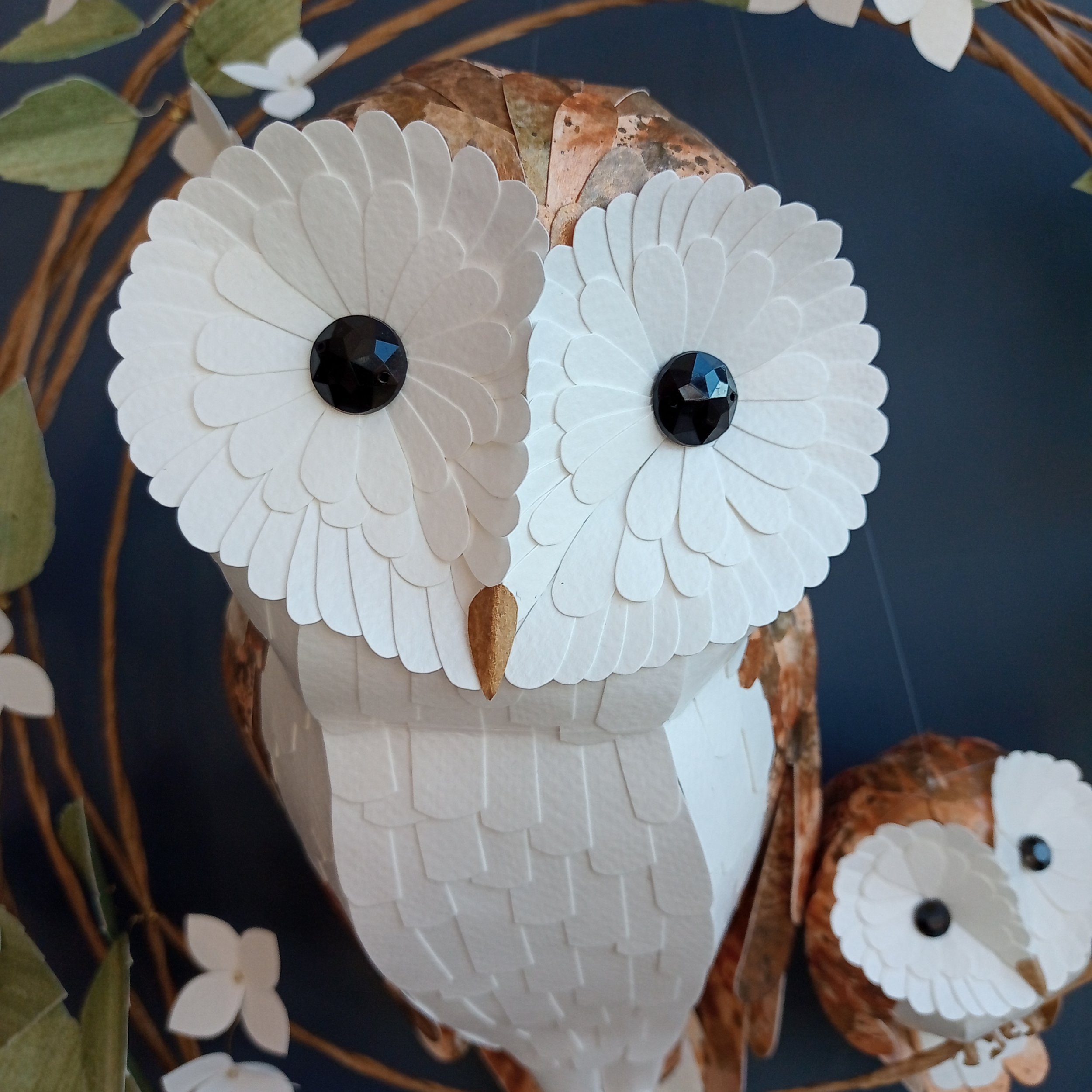 close up of the face of a handmade barn owl sculpture