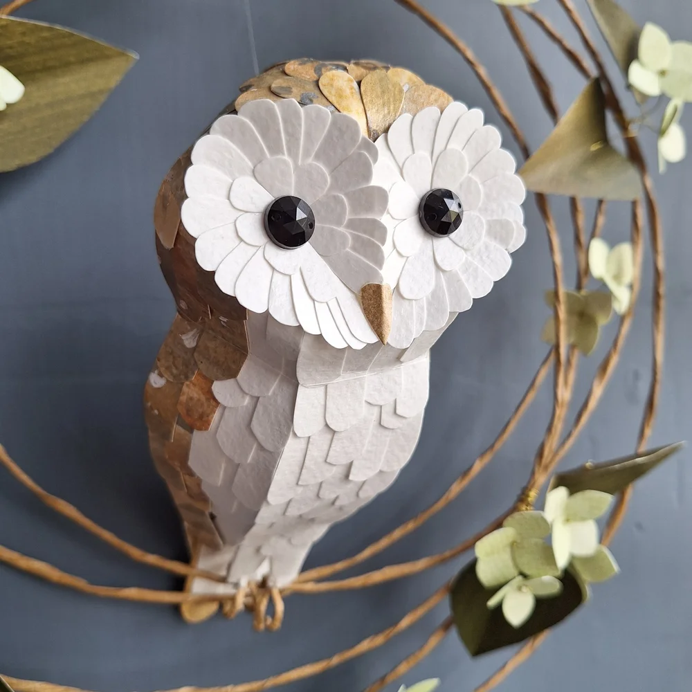 A small barn owl sculpture made from handprinted papers. Buy