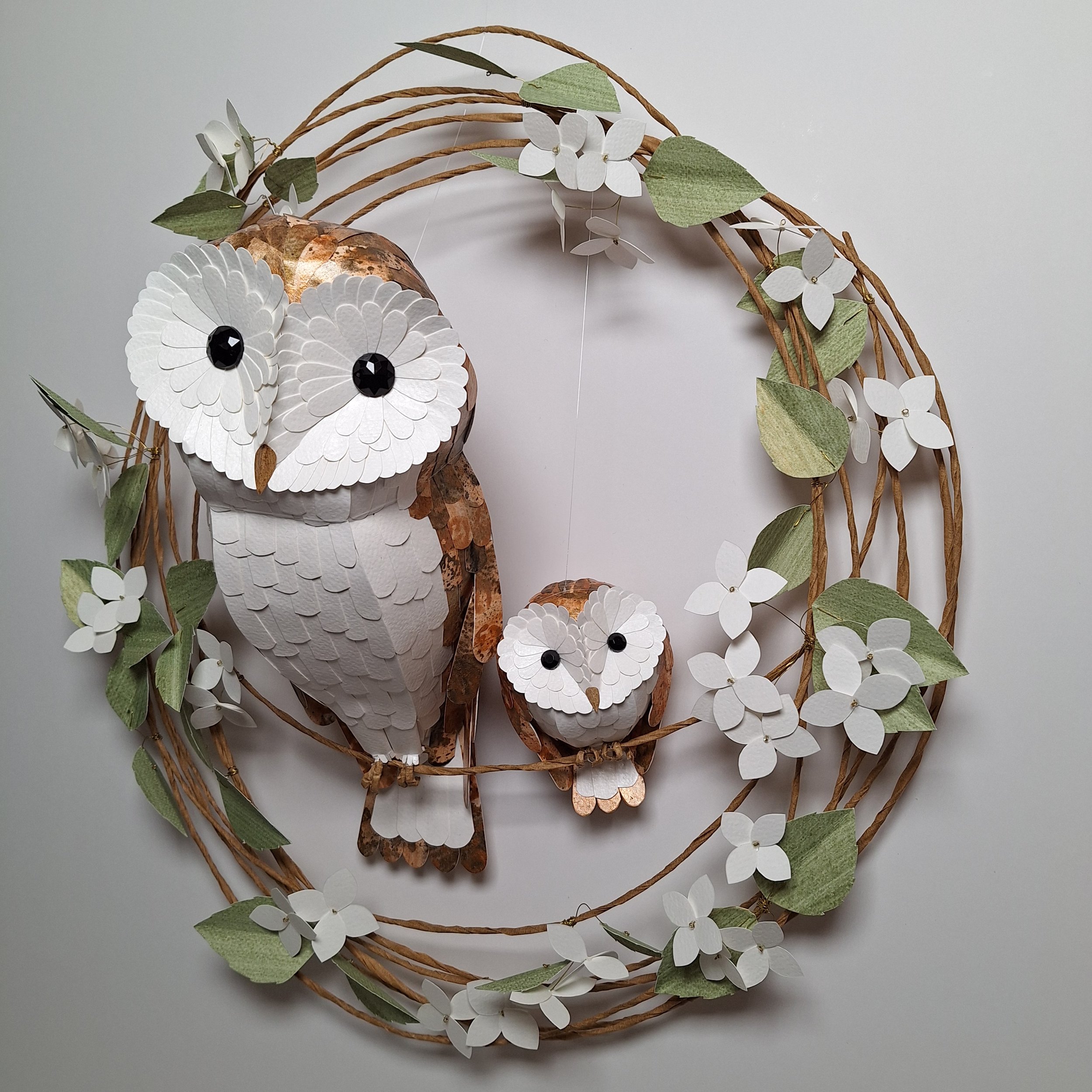 Bird themed home décor, featuring handmade sculptures of a barn owl mama and baby, perched on a wreath of white hydrangea blooms