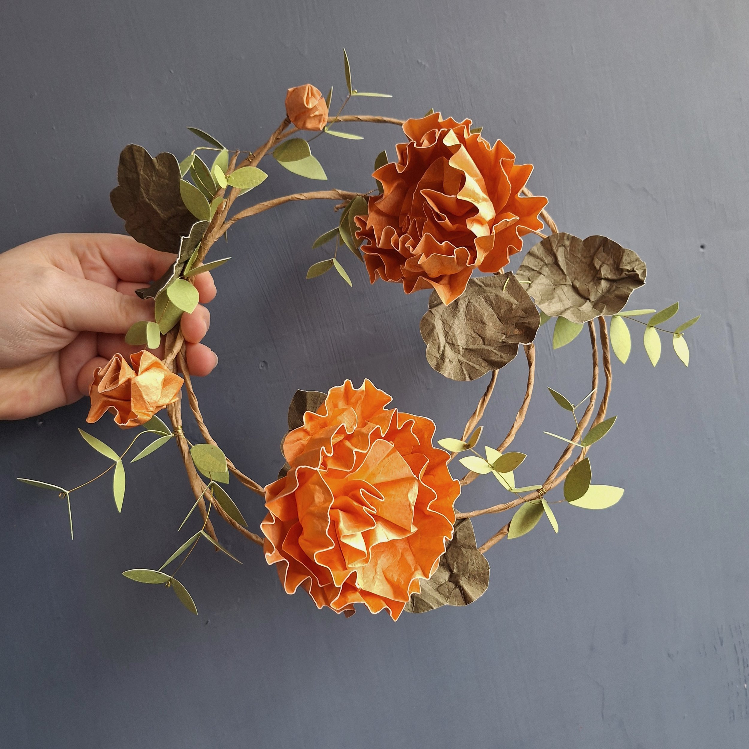 handmade paper flower wreath, featuring orange hollyhocks