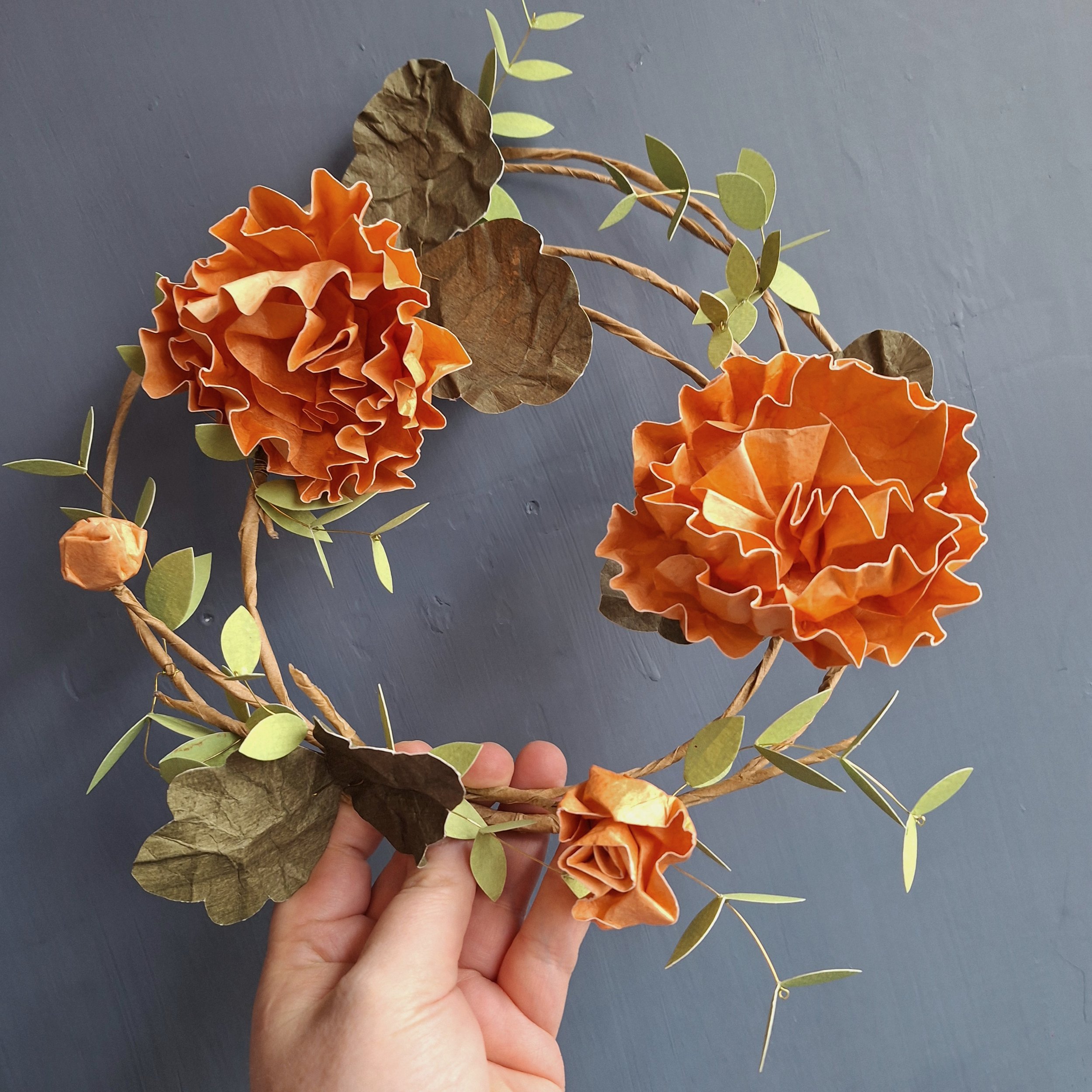 bespoke floral wreath, featuring orange hollyhock paper flowers and leaves