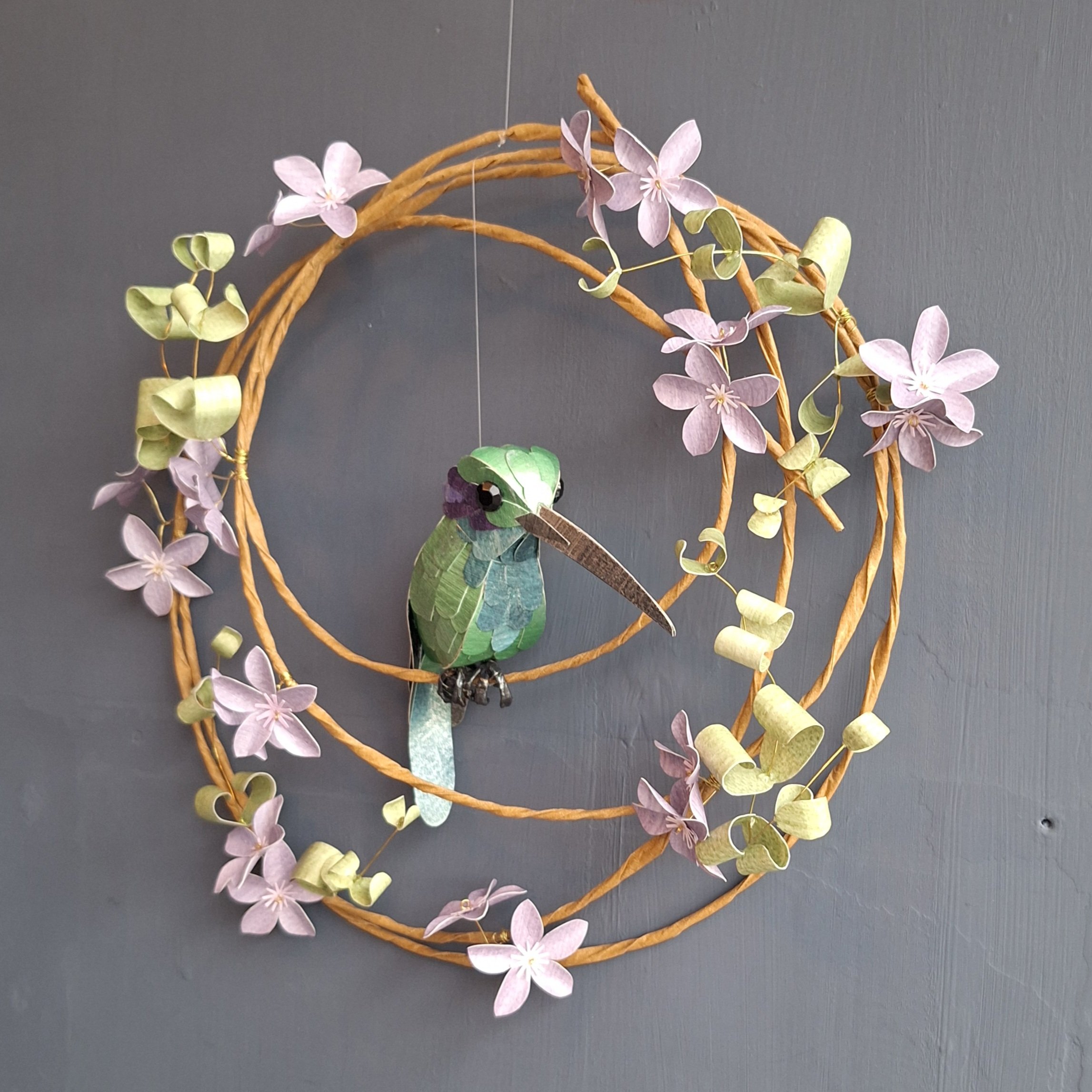 This Mexican Violetear hummingbird sculpture is mostly green, with a teal belly and violet purple ear patches.