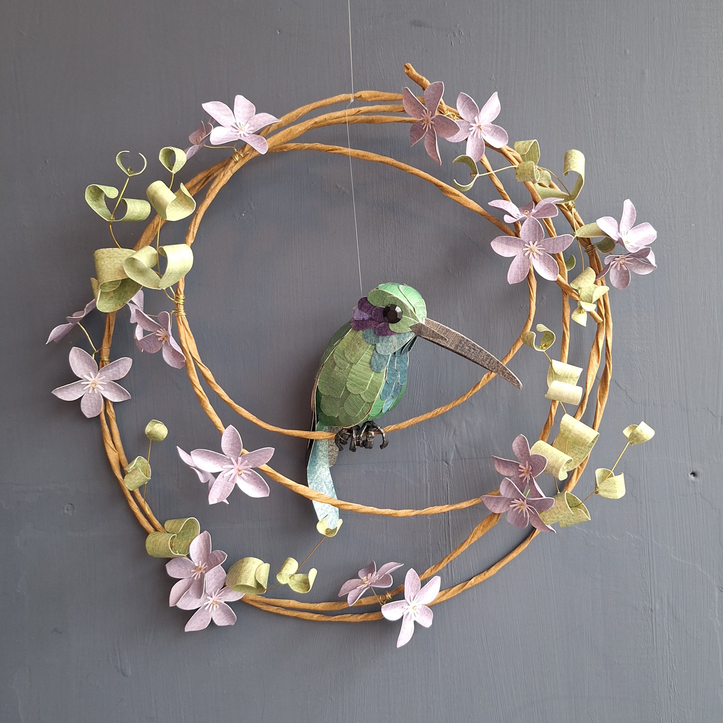 handmade wall art featuring a Mexican Violetear Hummingbird, perched on a wreath of purple flowers and green leaves