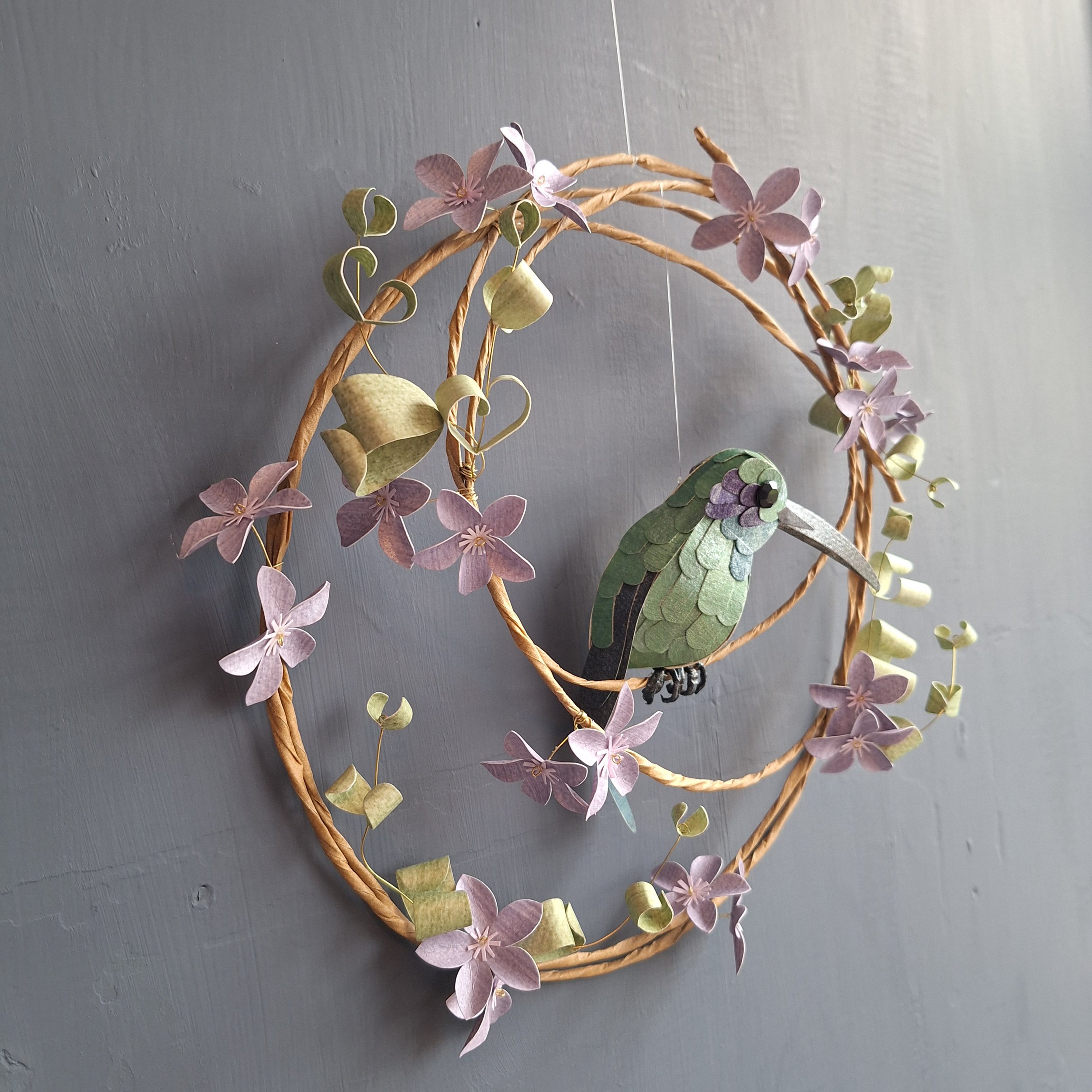 side view of a hummingbird sculpture wall hanging