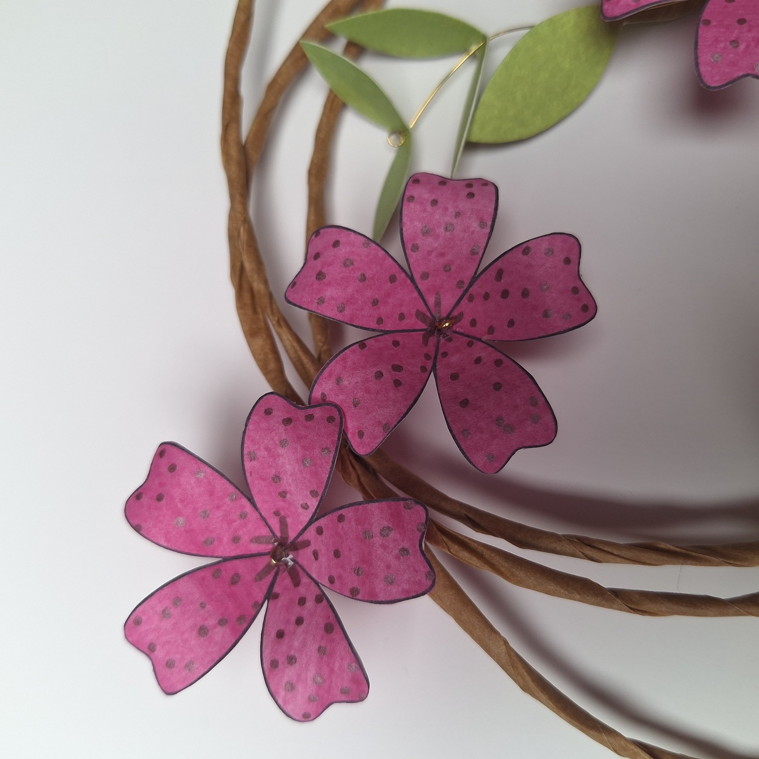close up view of bright pink handmade paper flowers