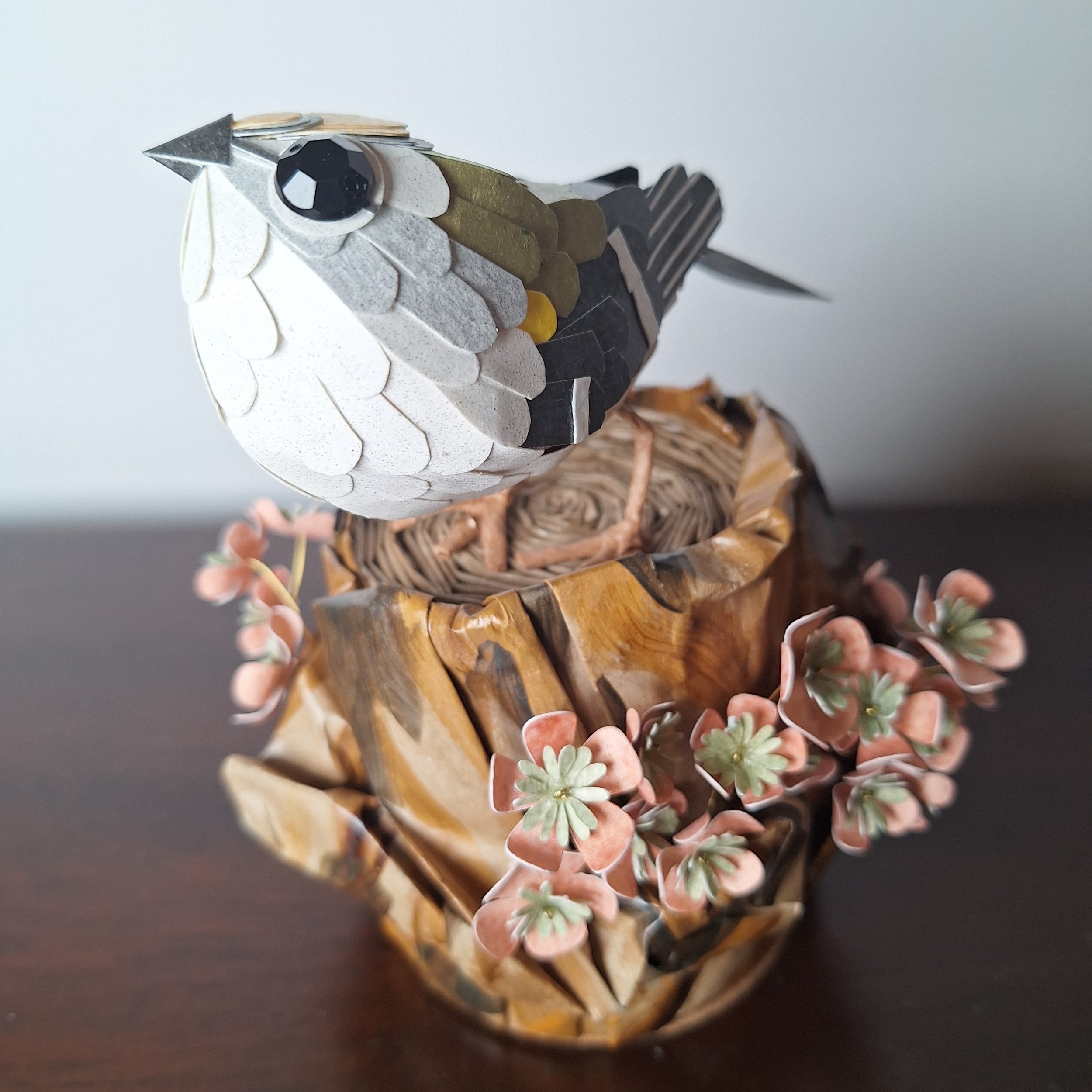 goldcrest on a tree stump. Paper sculpture art by Kaper