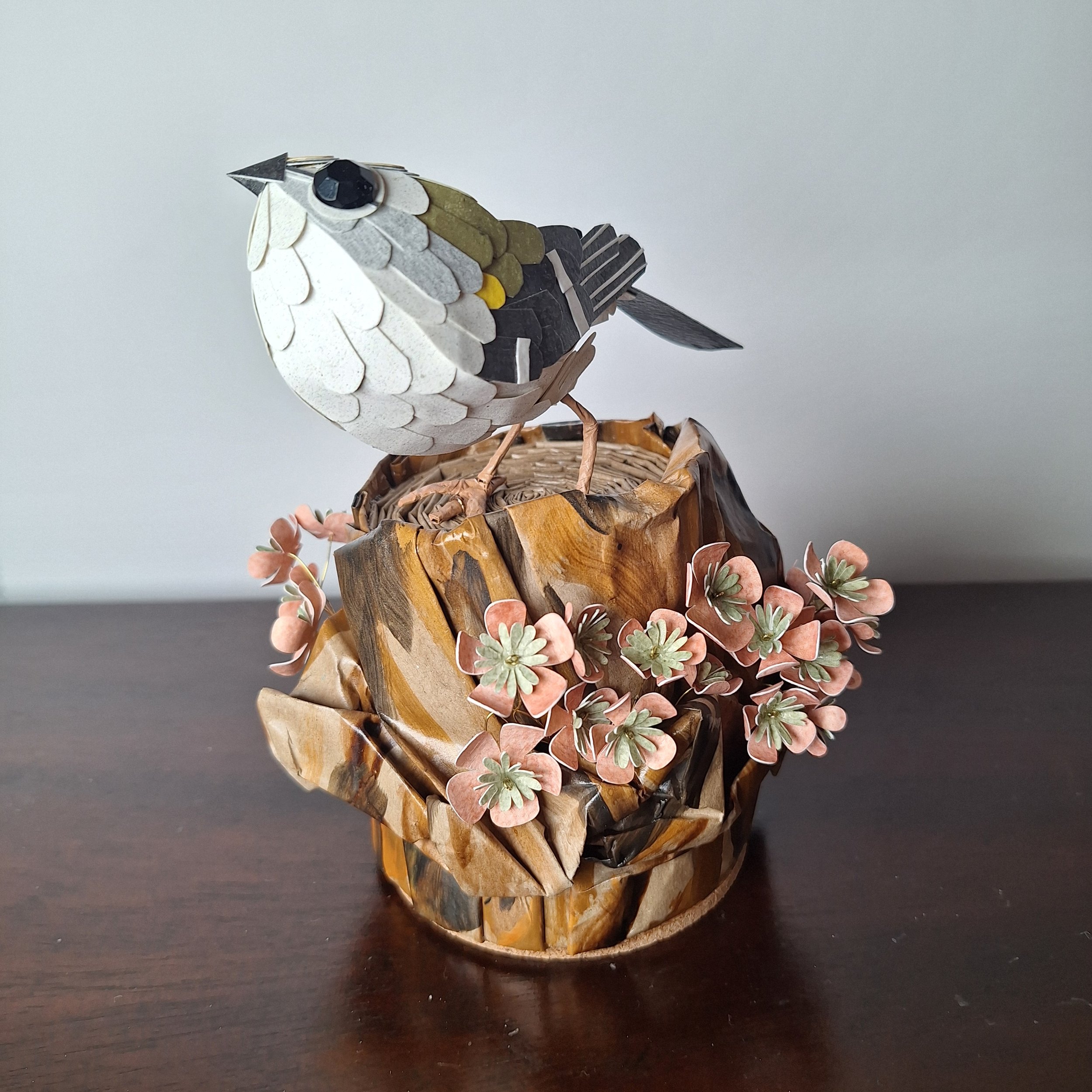 goldcrest on a tree stump. Paper sculpture art by Kaper