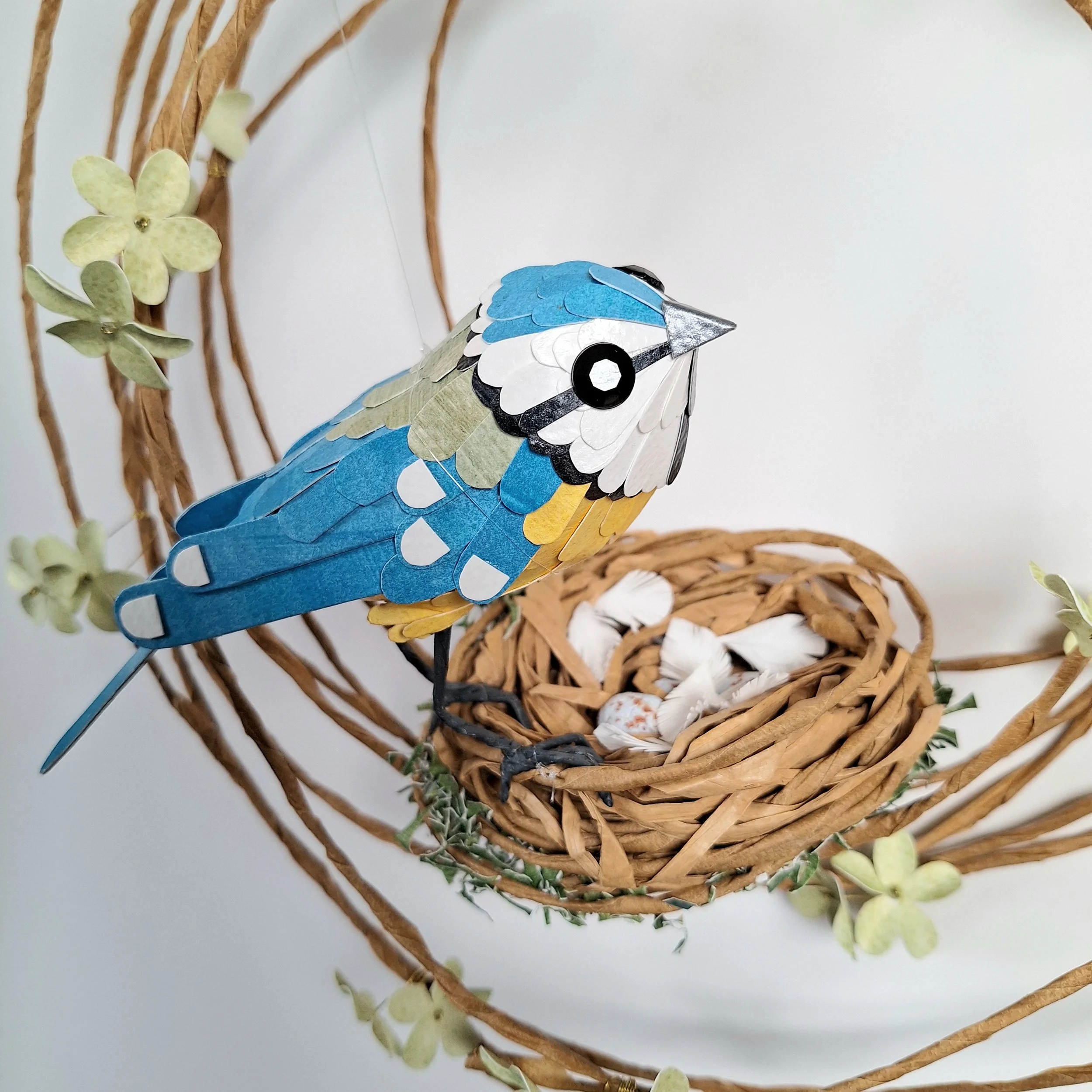 Close up of a blue tit sculpture handmade from paper.